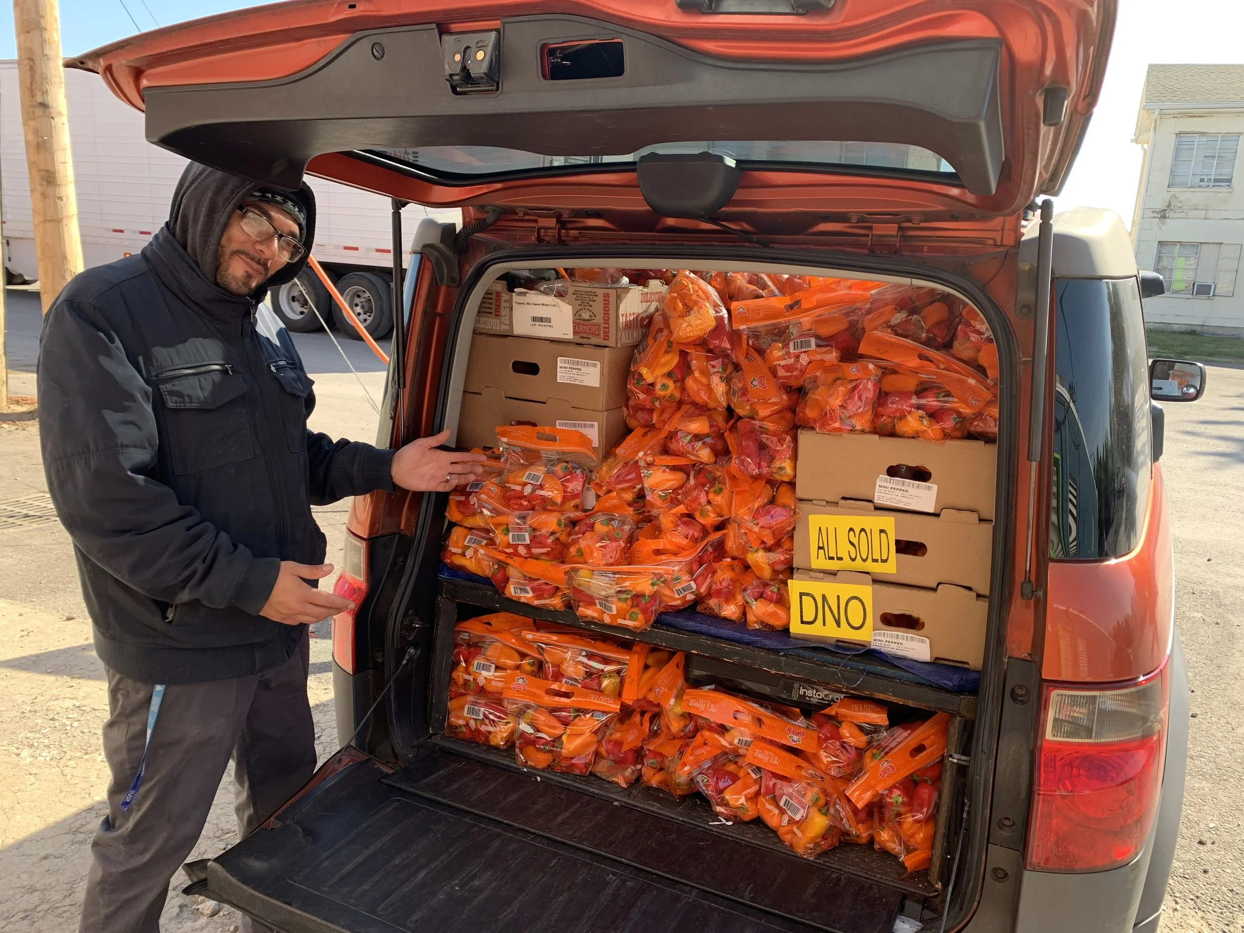 DNO team member helps load truck with produce for Food Rescue Columbus