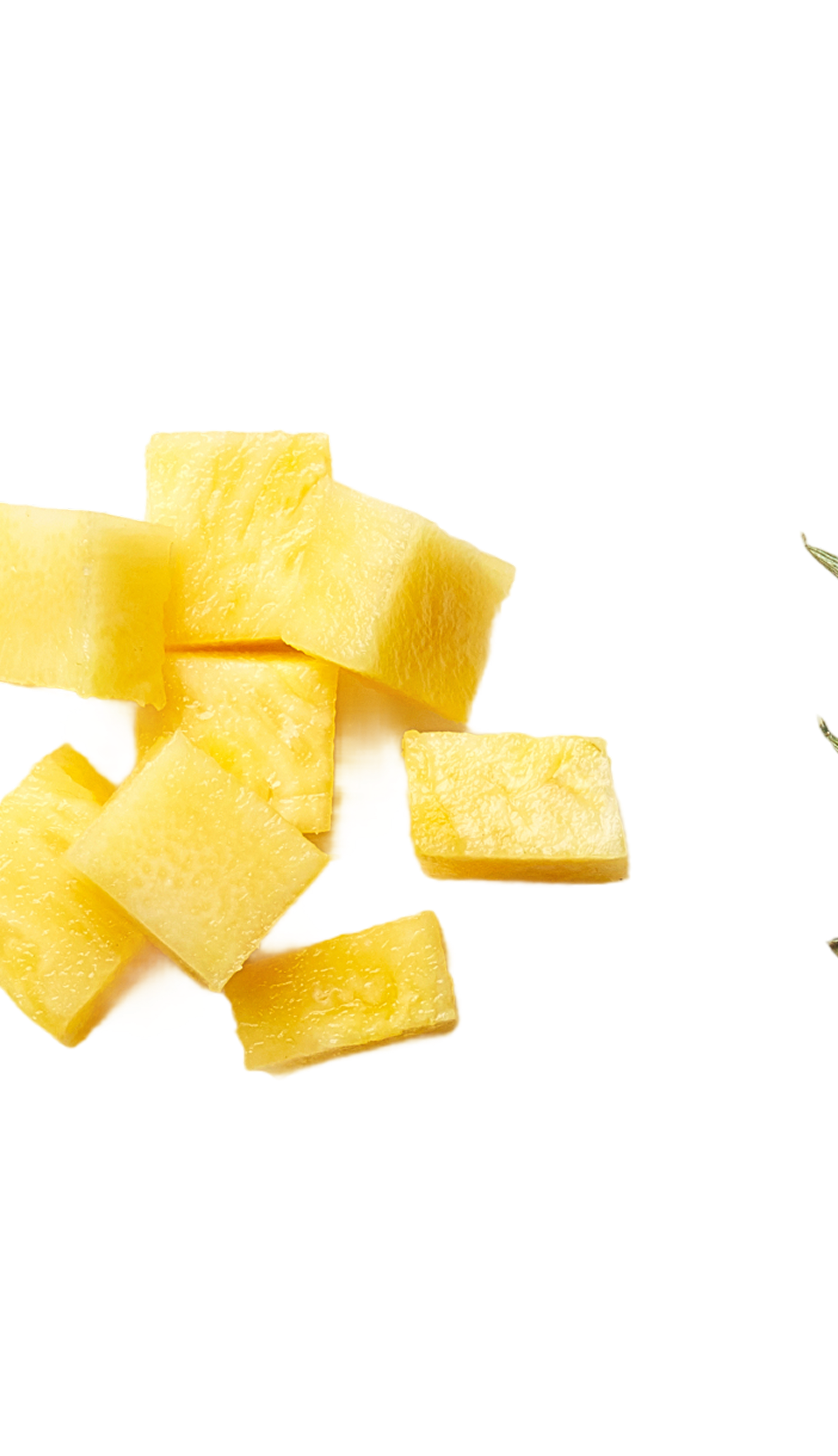 Cubed pieces of yellow mango fruit scattered on a black background.