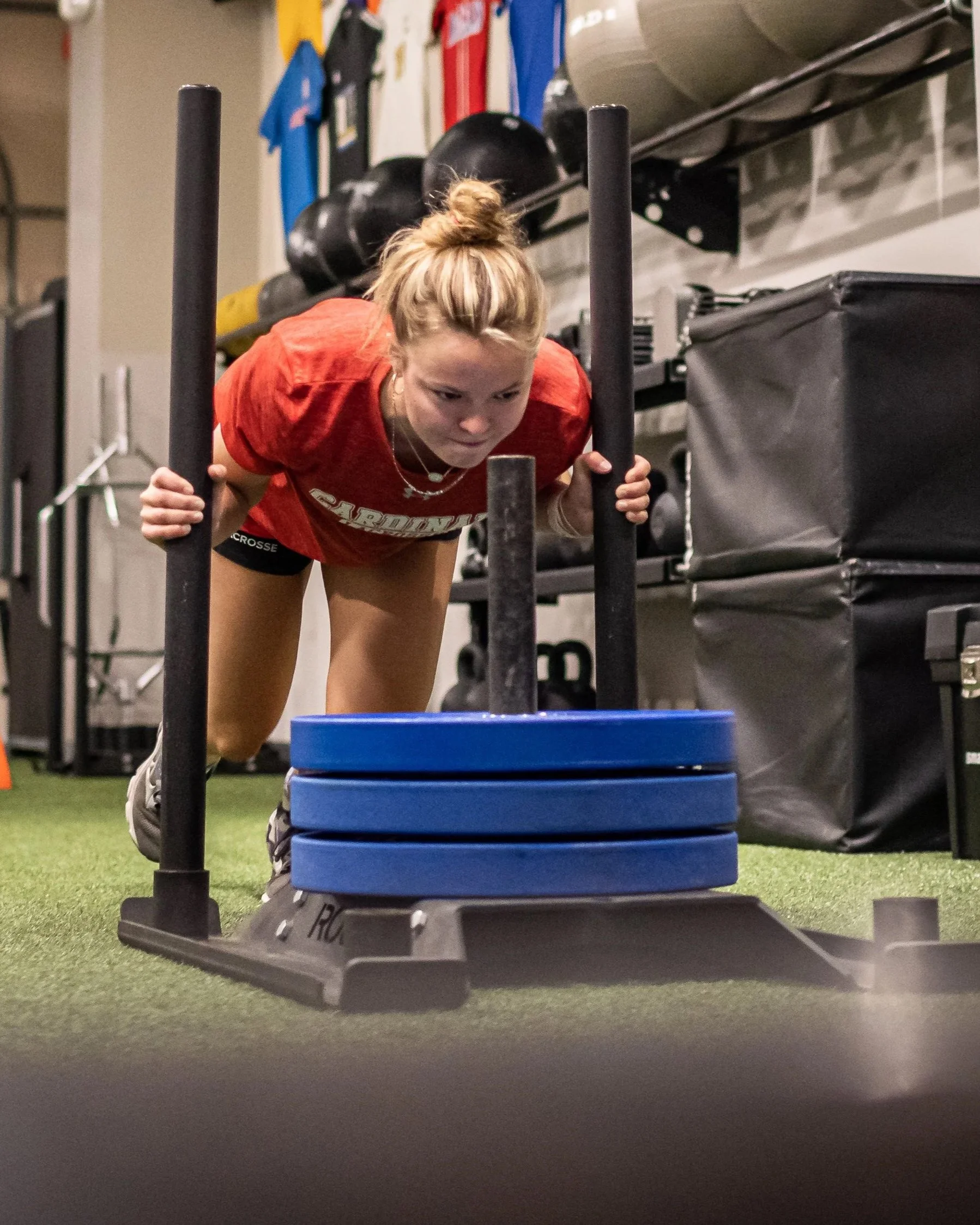 Athlete performing sled push during performance training