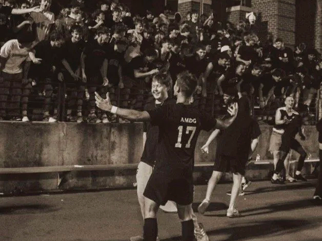 Soccer players celebrating a win