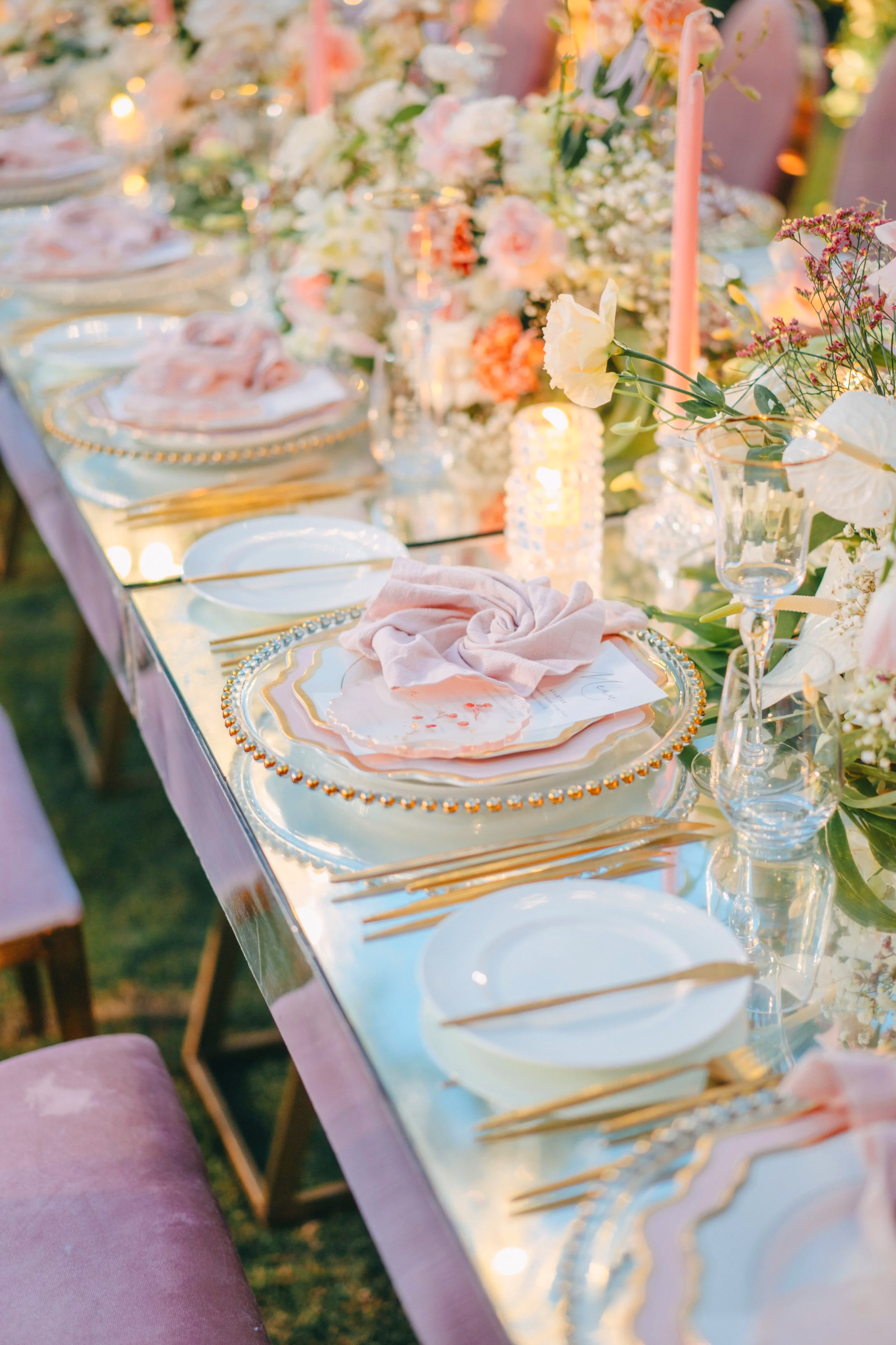 A long banquet table decorated with flowers, candles, and elegant tableware for an outdoor event. Wedding Content Creators in Hong Kong.