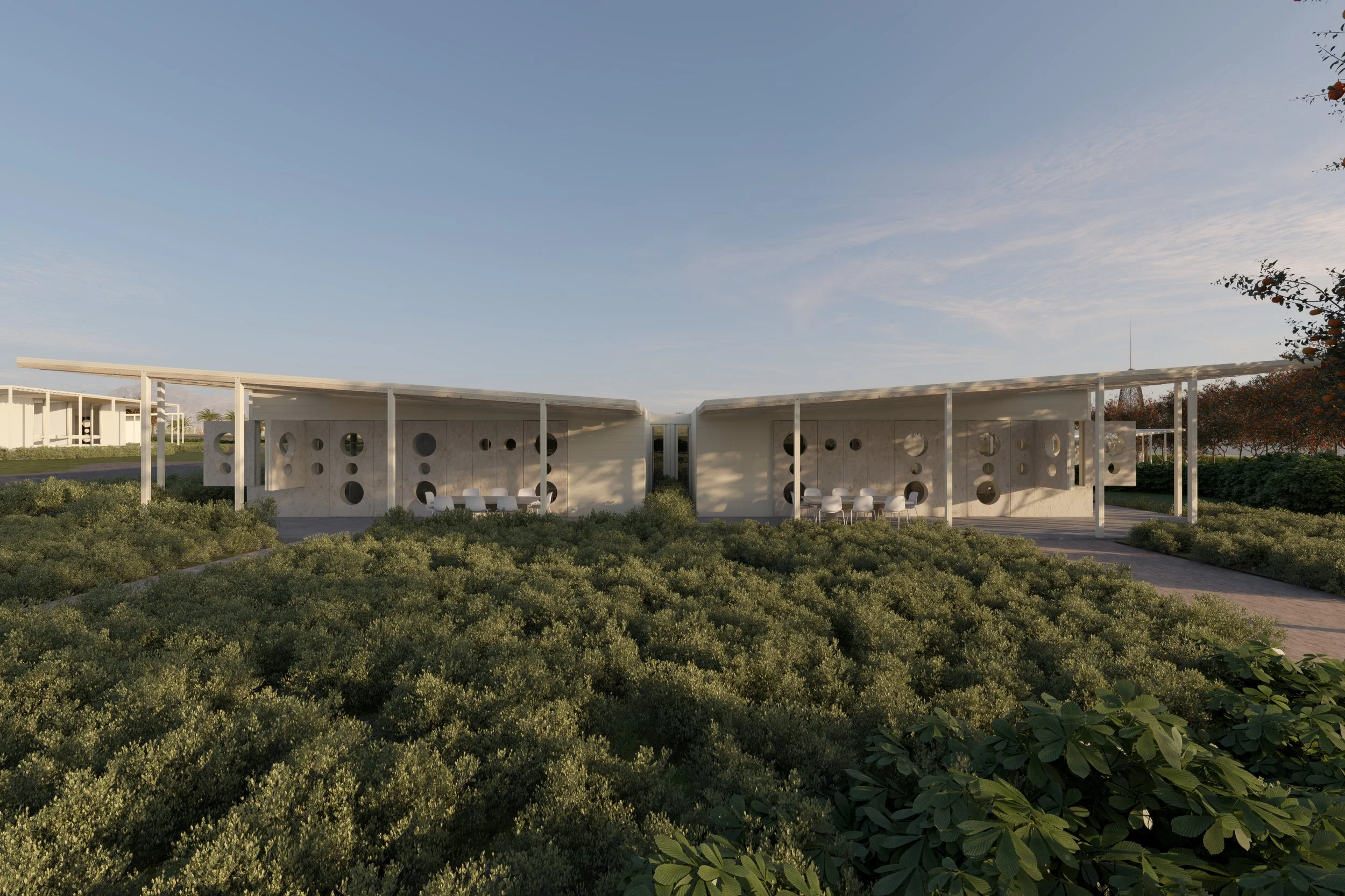 Estructura moderna con paredes de hormigón y círculos en las paredes, rodeada de vegetación, en un día soleado con cielo despejado. Architecture & Design by Rafael Aragonés Caballero & Miguel Ángel Aragonés | Taller Aragonés. Rendering: Oscar Velez