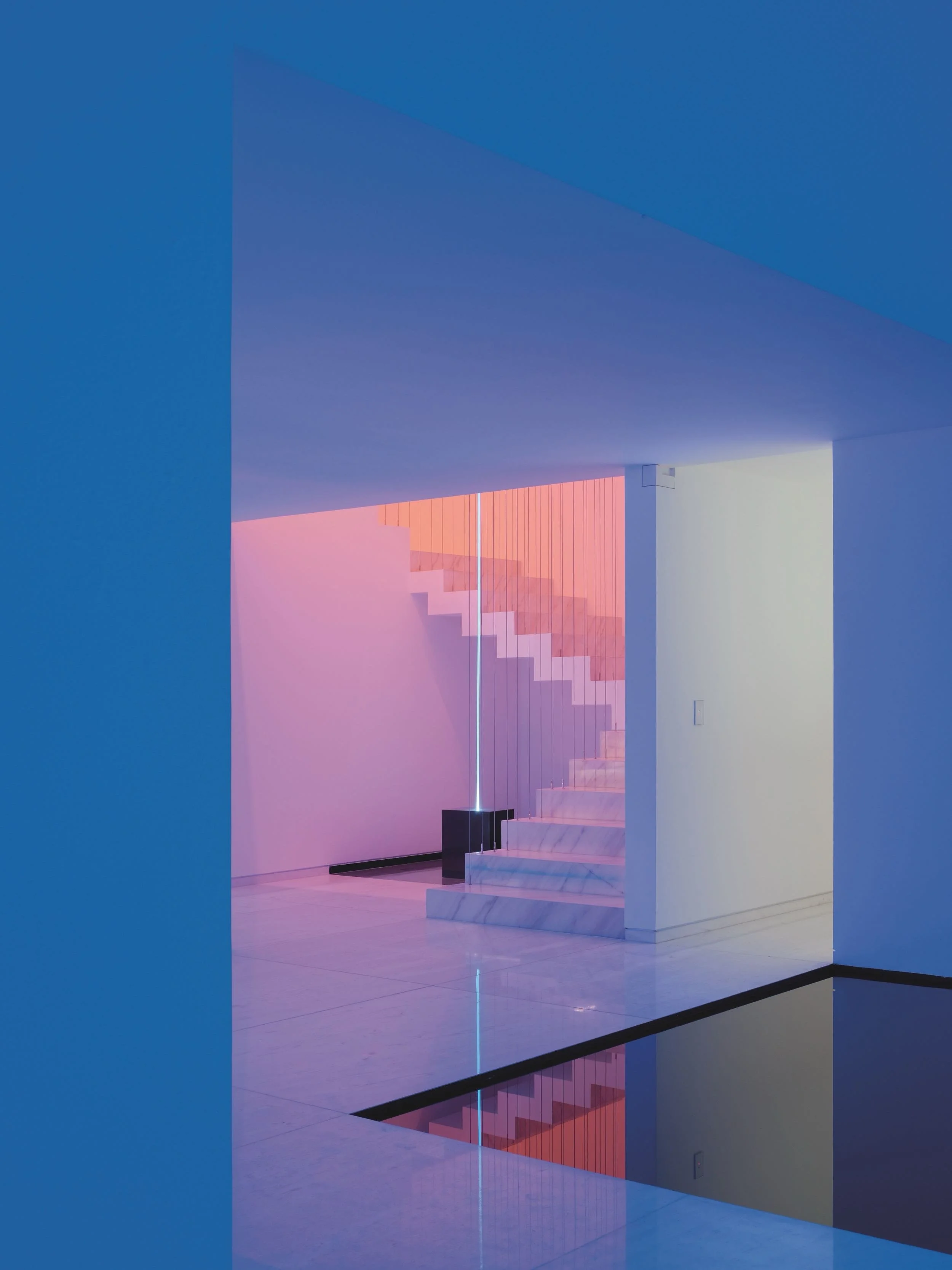 Rombo IV by Miguel Angel Aragonés: A masterpiece of contemporary Mexican architecture and minimalist interior design, featuring sculptural stairs and chromatic light. Photo by Joe Fletcher.