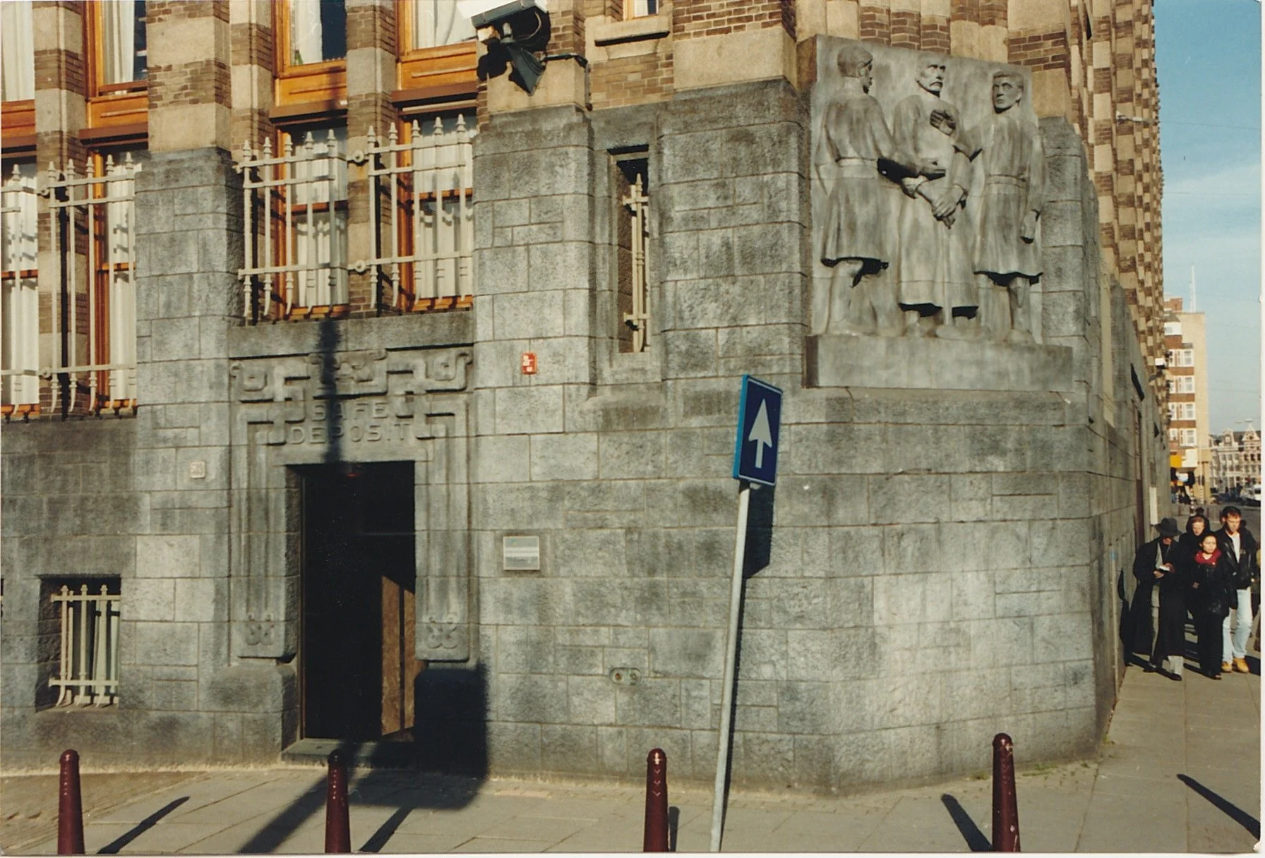 Monumental stone building featuring relief sculptures carved into its façade.