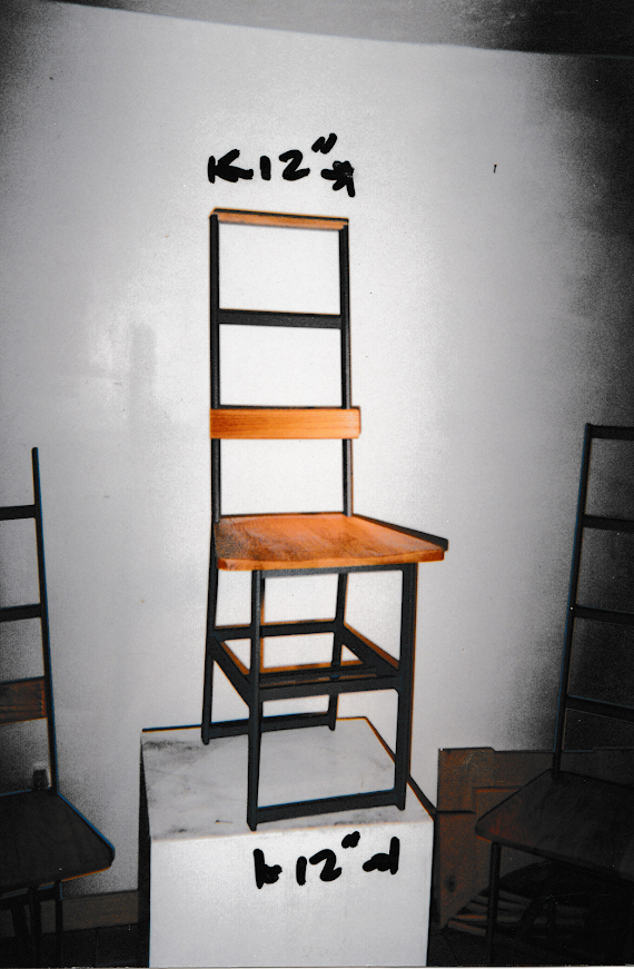 Prototype chair displayed on a pedestal with handwritten dimensions above and below.