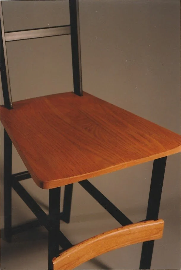 Close-up photograph of the wooden seat surface and surrounding frame.