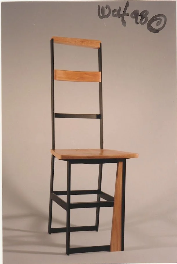 Front view of a modern ladder-back chair with wood seat and centered back support.