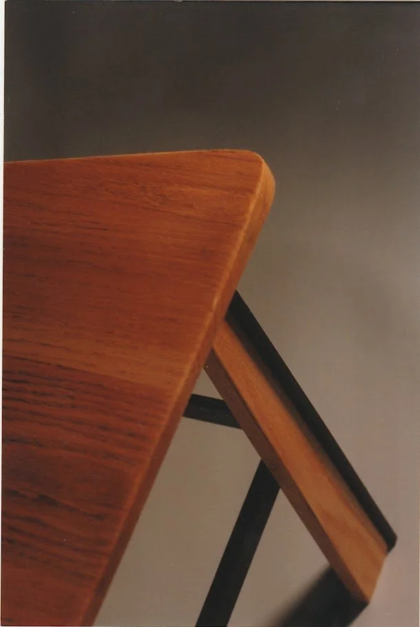 Detail photograph of a polished wooden seat corner and edge profile.