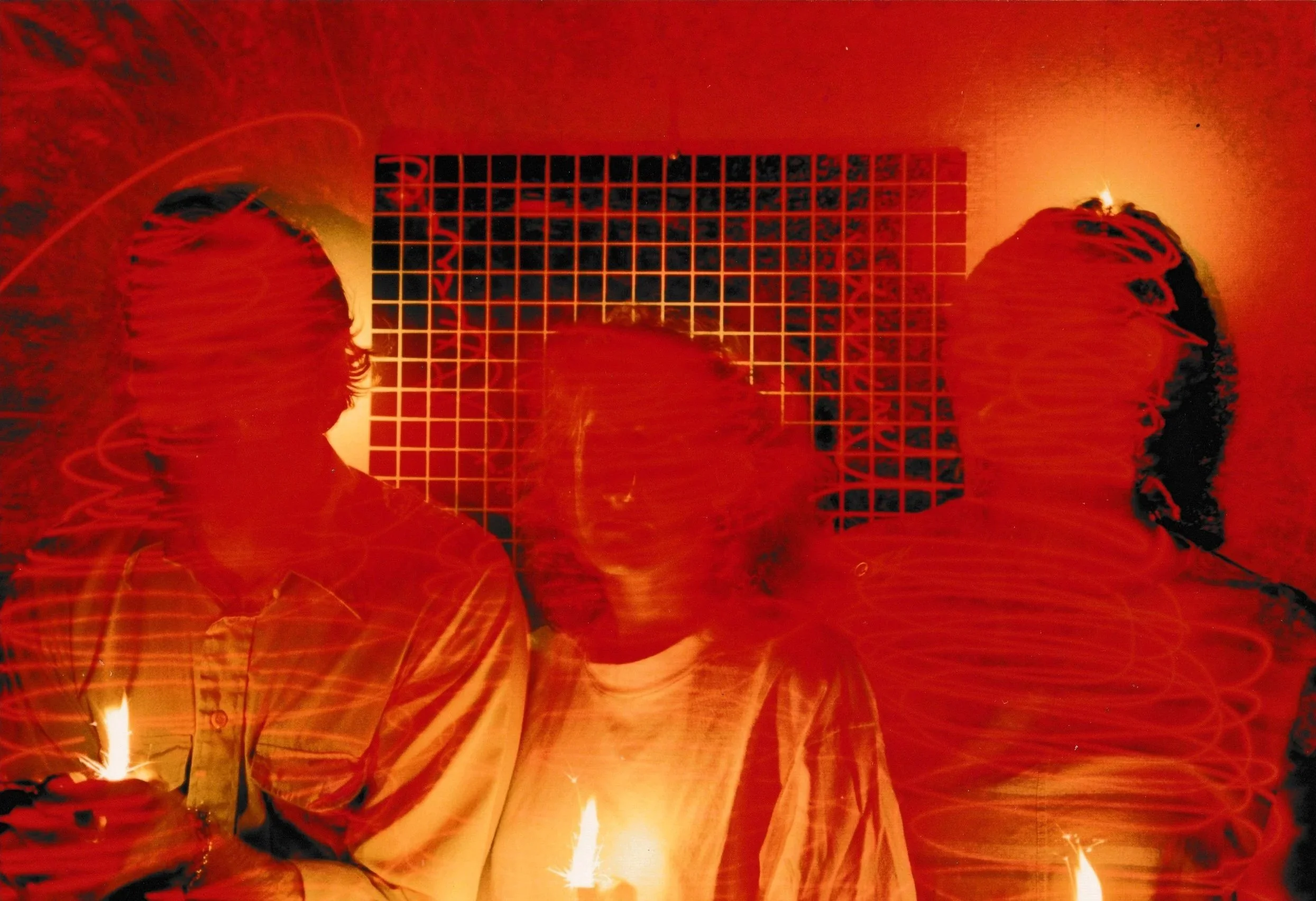 Shadowy human silhouette projected onto a red-lit wall within an immersive laser installation.