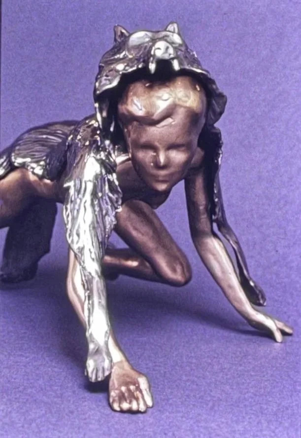 Frontal view of the same wolf-headed figure, emphasizing the alert expression beneath the animal mask.