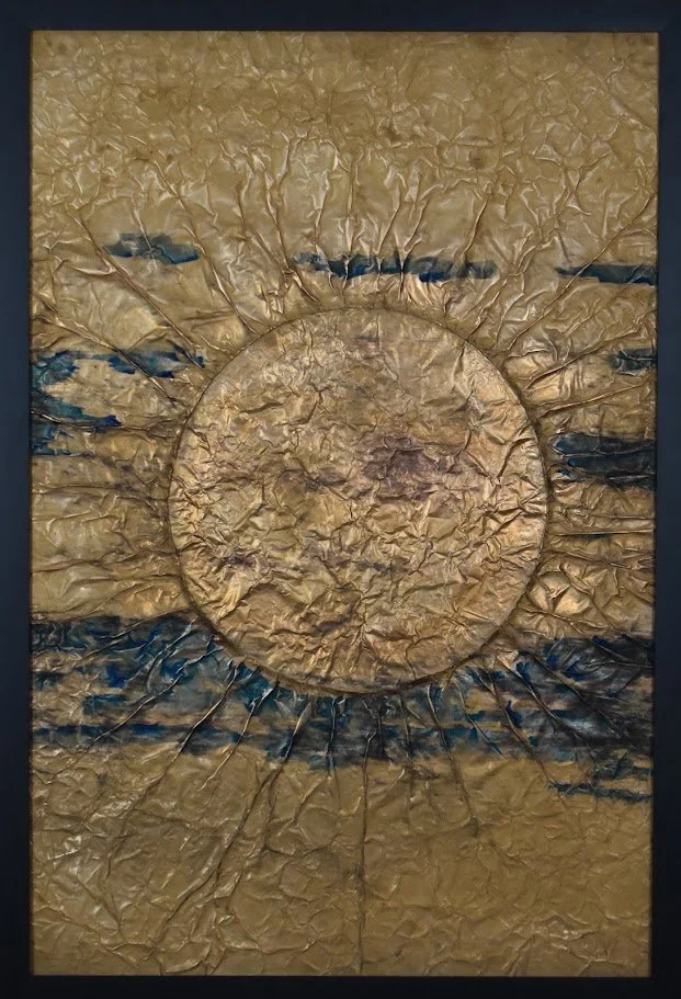 A golden orb radiates through dark horizontal currents. Shown close up in a black frame.