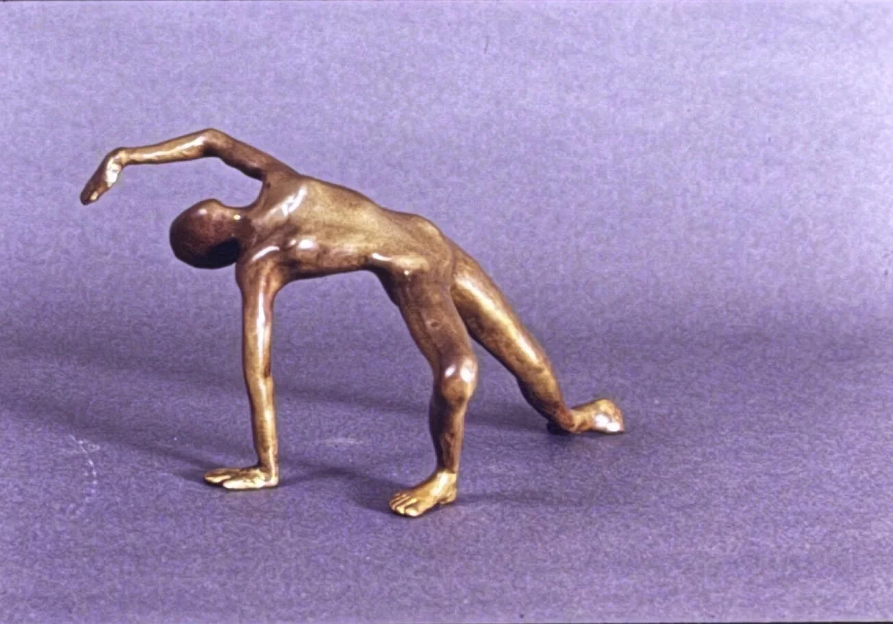 Bronze acrobatic figure frozen in a deep backbend, supported by one hand and both feet while the torso arches into a sweeping crescent shape.