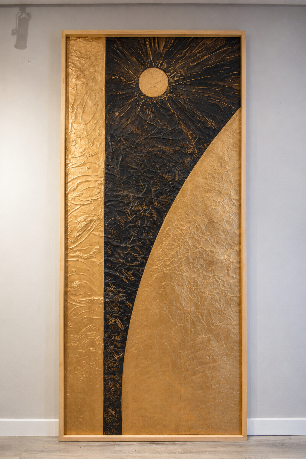 A radiant orb rises beside a sweeping golden planetary arc. Displayed framed on a white wall.
