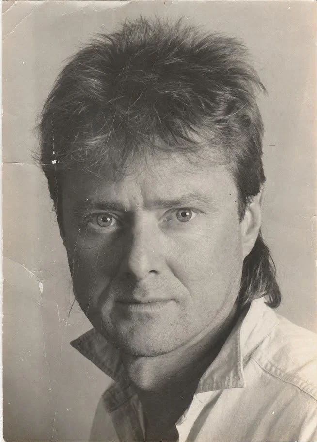 Whitney Wolf II featured in a black-and-white headshot. Circa 1980s