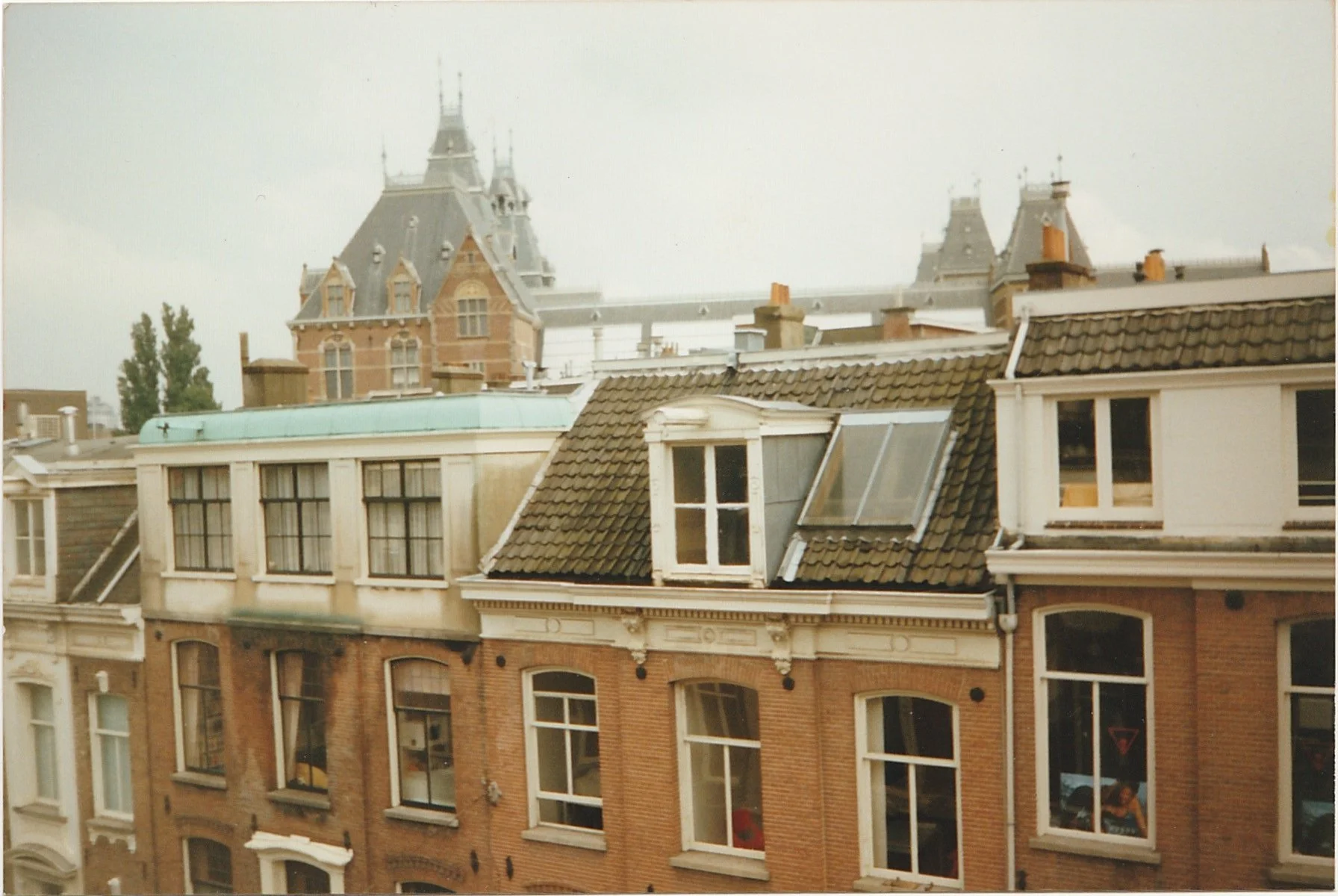 Rooftop view across historic European buildings with decorative gables and chimneys.