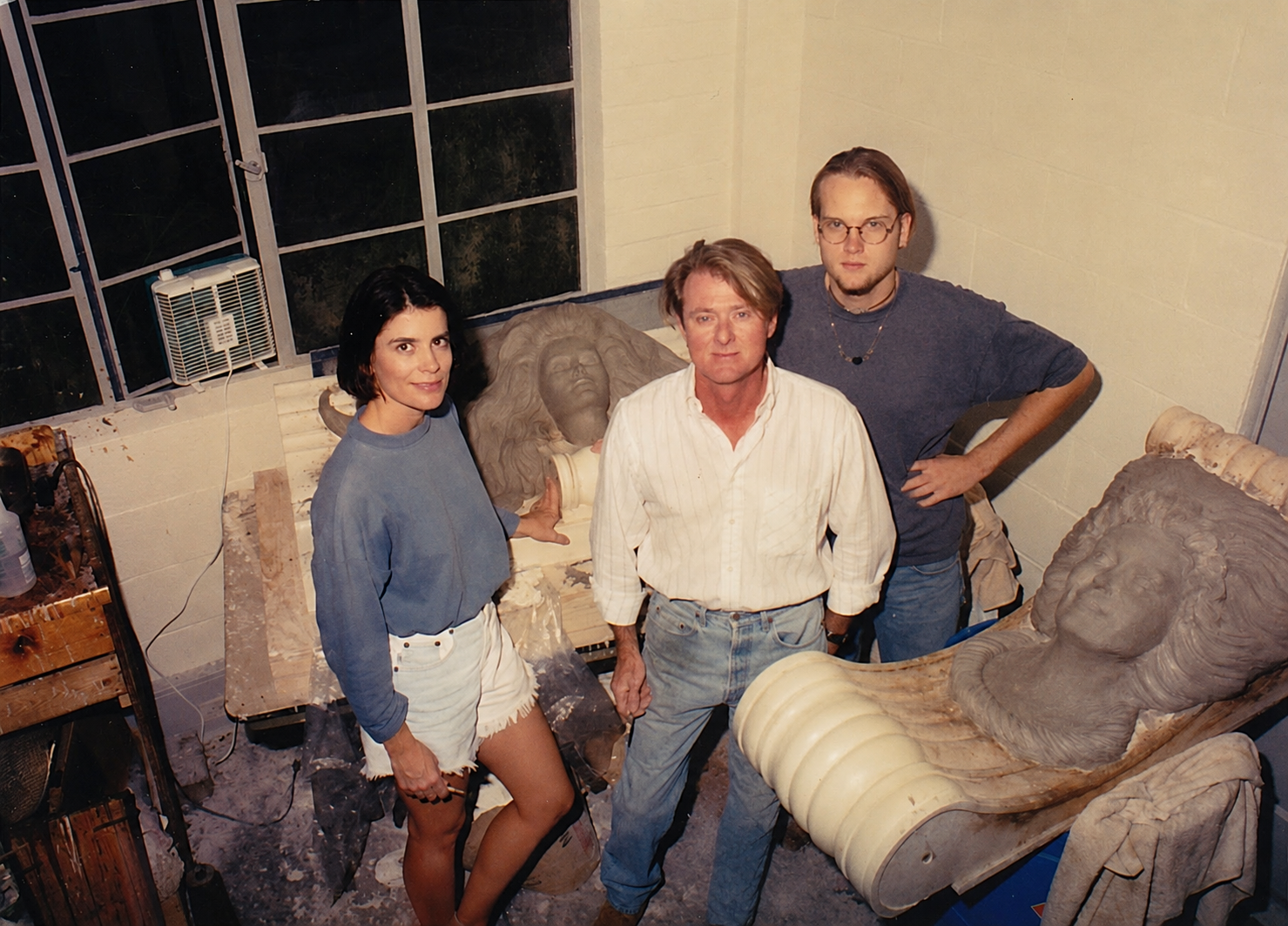 Whitney Wolf II, Jamie Travis, and Kathryn stand between two works of progress. They were sculpting two beautiful woman with long hair made out of clay. 