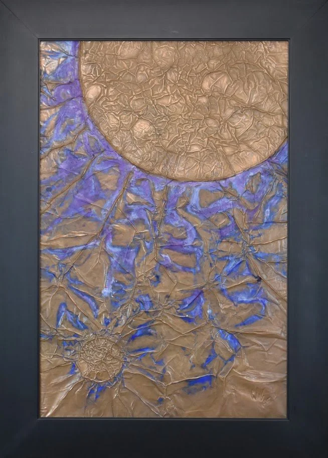 Golden orbs emerge through vivid blue currents. Shown close up in a black frame.