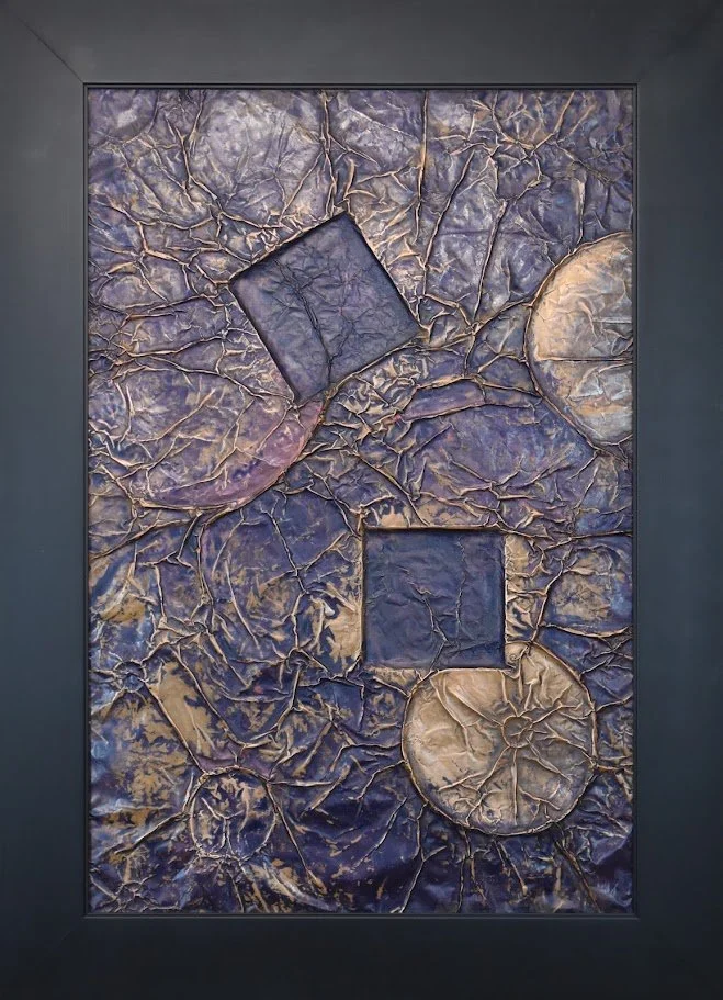 Geometric forms float within a fractured violet field. Shown close up in a frame.
