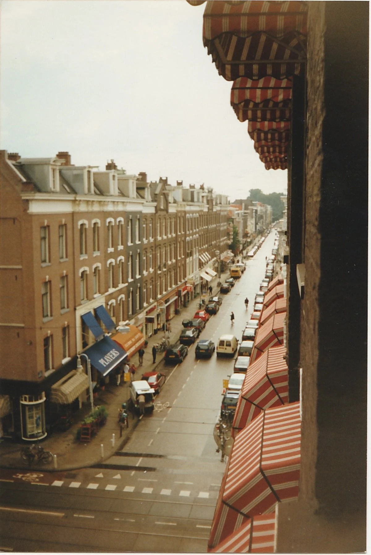 Elevated view down a historic European street lined with brick buildings.