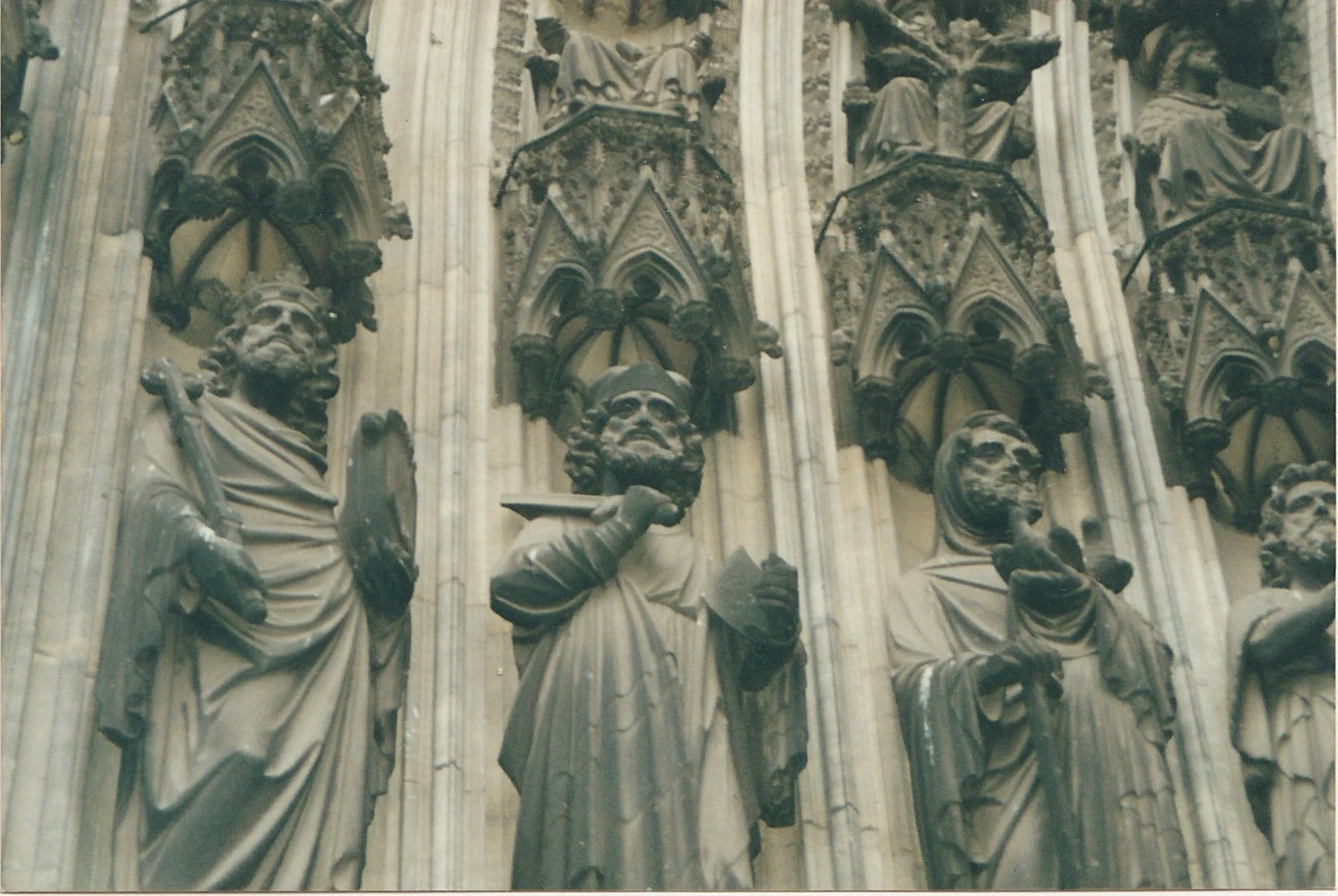 Close-up of Gothic cathedral sculptures carved into an elaborate stone façade.