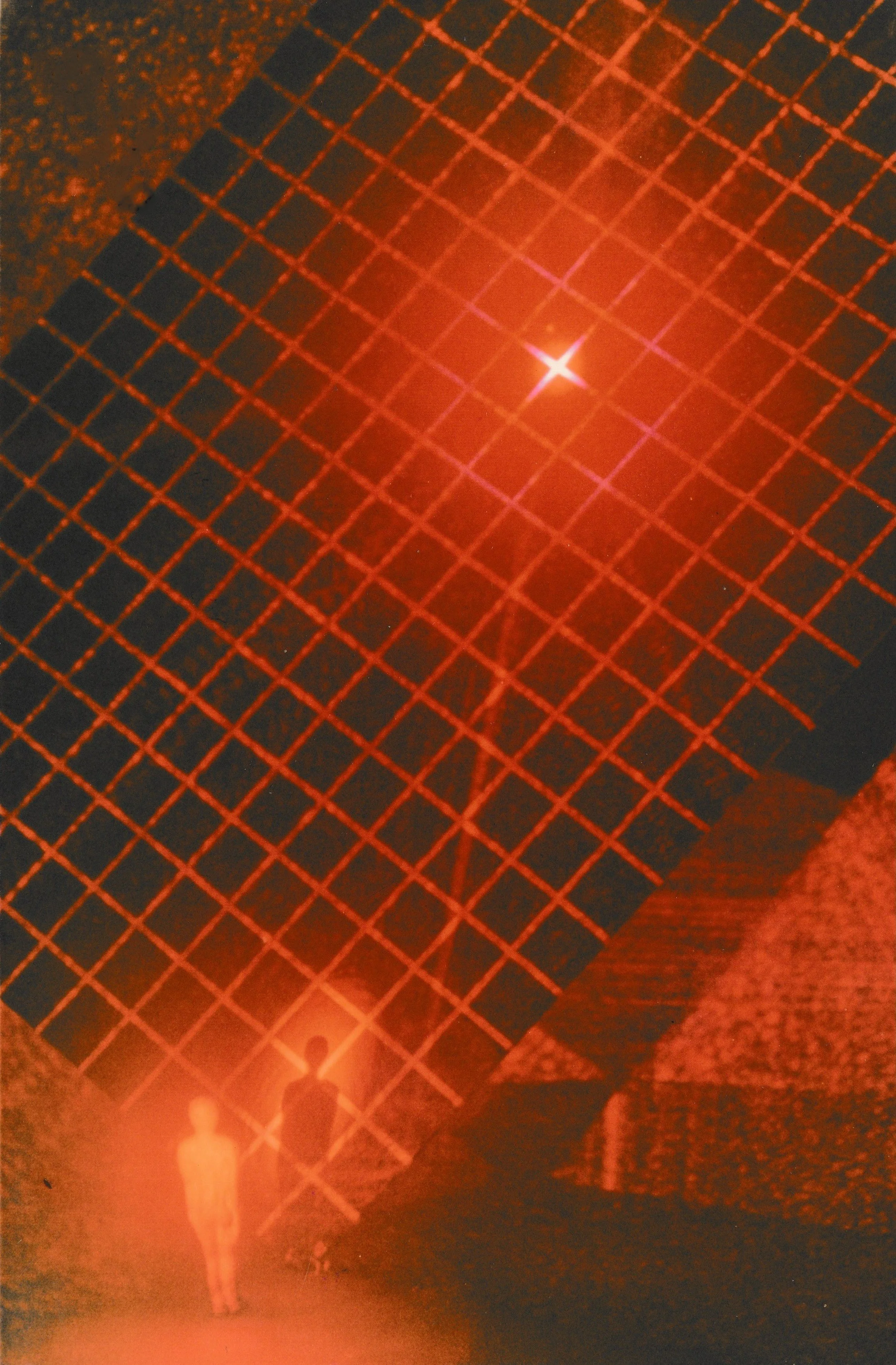 Human figure standing beneath a glowing red circular light surrounded by radiating laser beams and illuminated platforms.