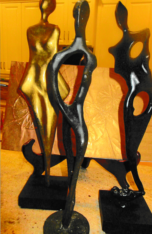Group of three elongated bronze abstract figures, each pierced with large open voids and standing on individual bases, their silhouettes twisting like wind-sculpted forms.