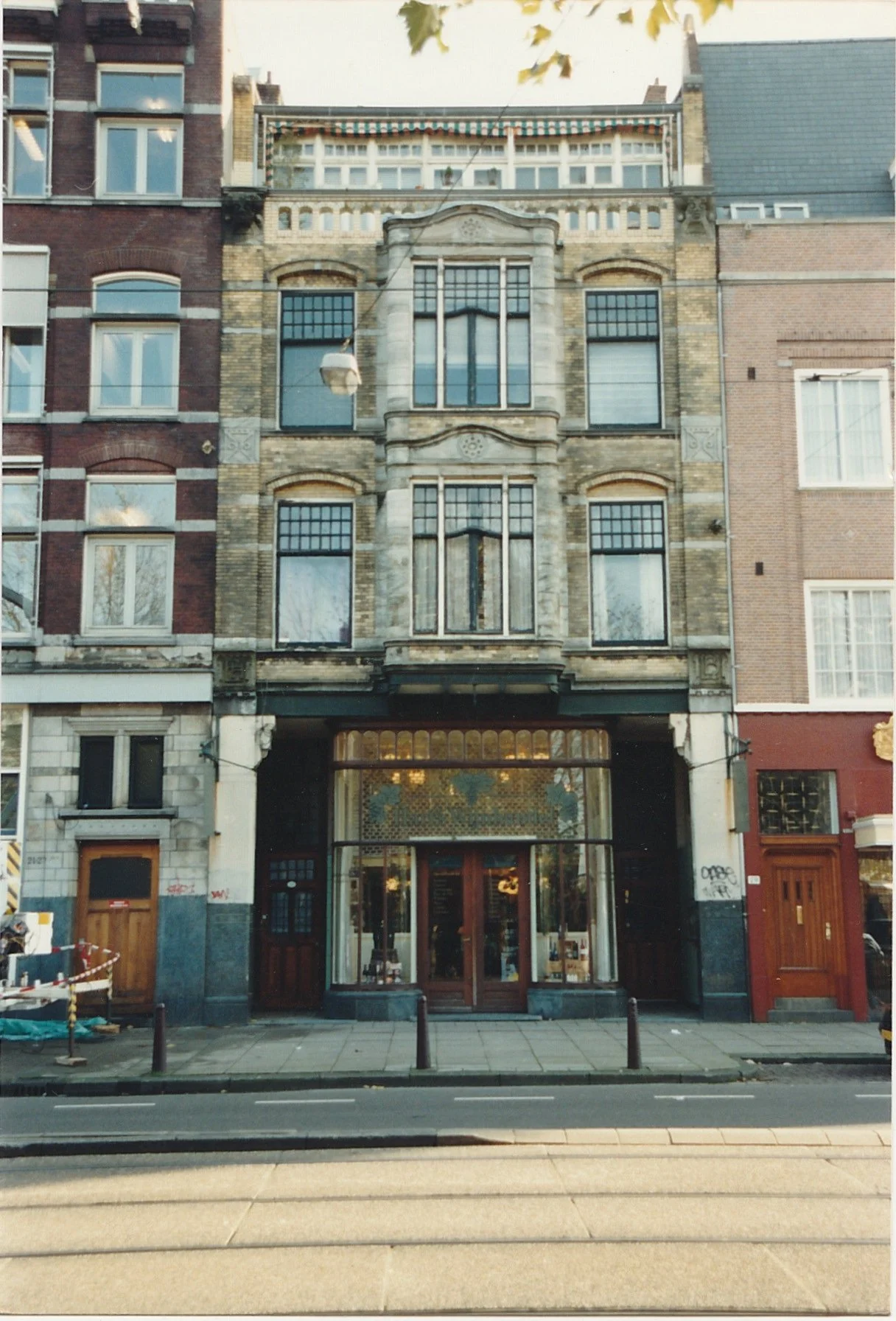 Ornate historic storefront and apartment building with decorative stonework.