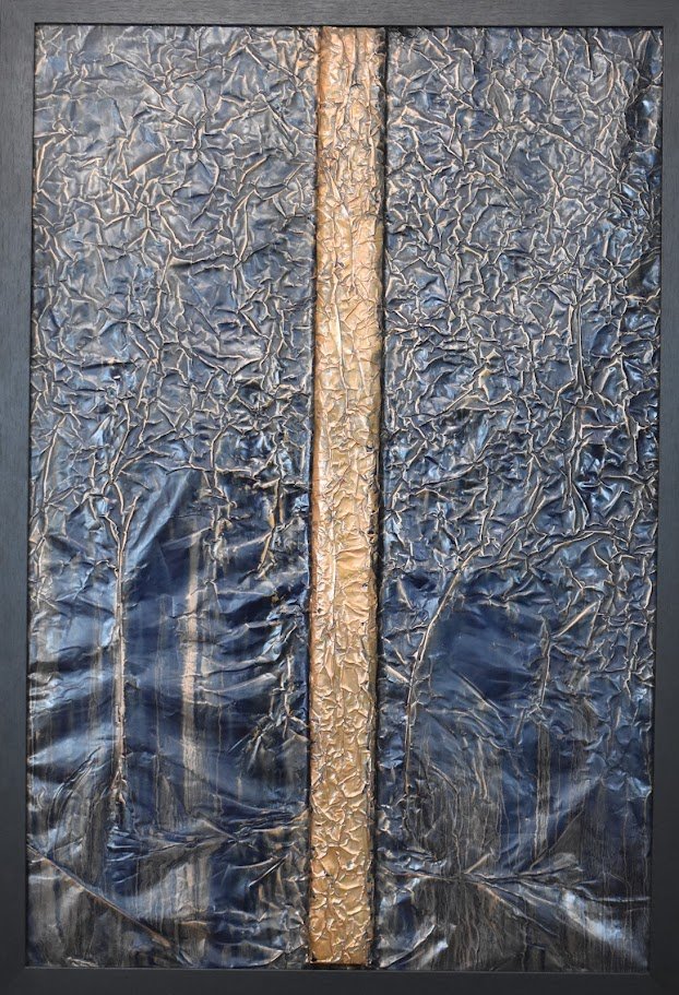 A golden vertical band divides a deep blue metallic field. Shown close up in a black frame.