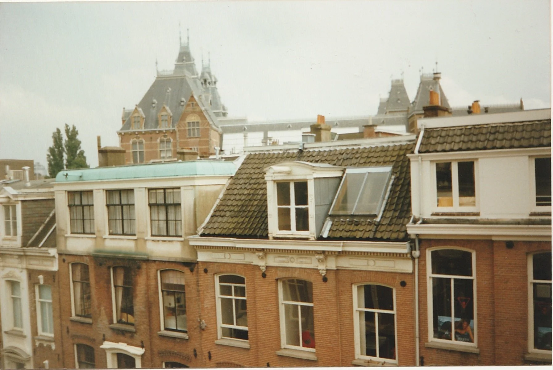 Rooftop cityscape featuring ornate historic architecture and dormer windows.