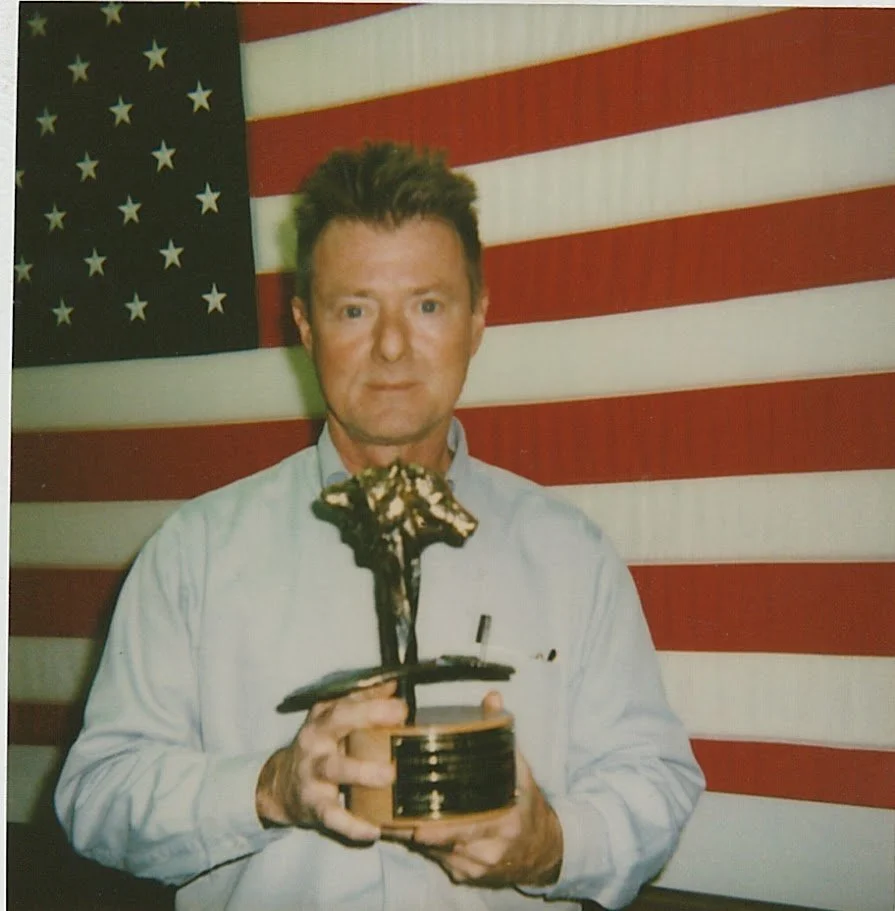 Whitney Wolf II holding an award that he either made for a company or received himself. Circa 1990s
