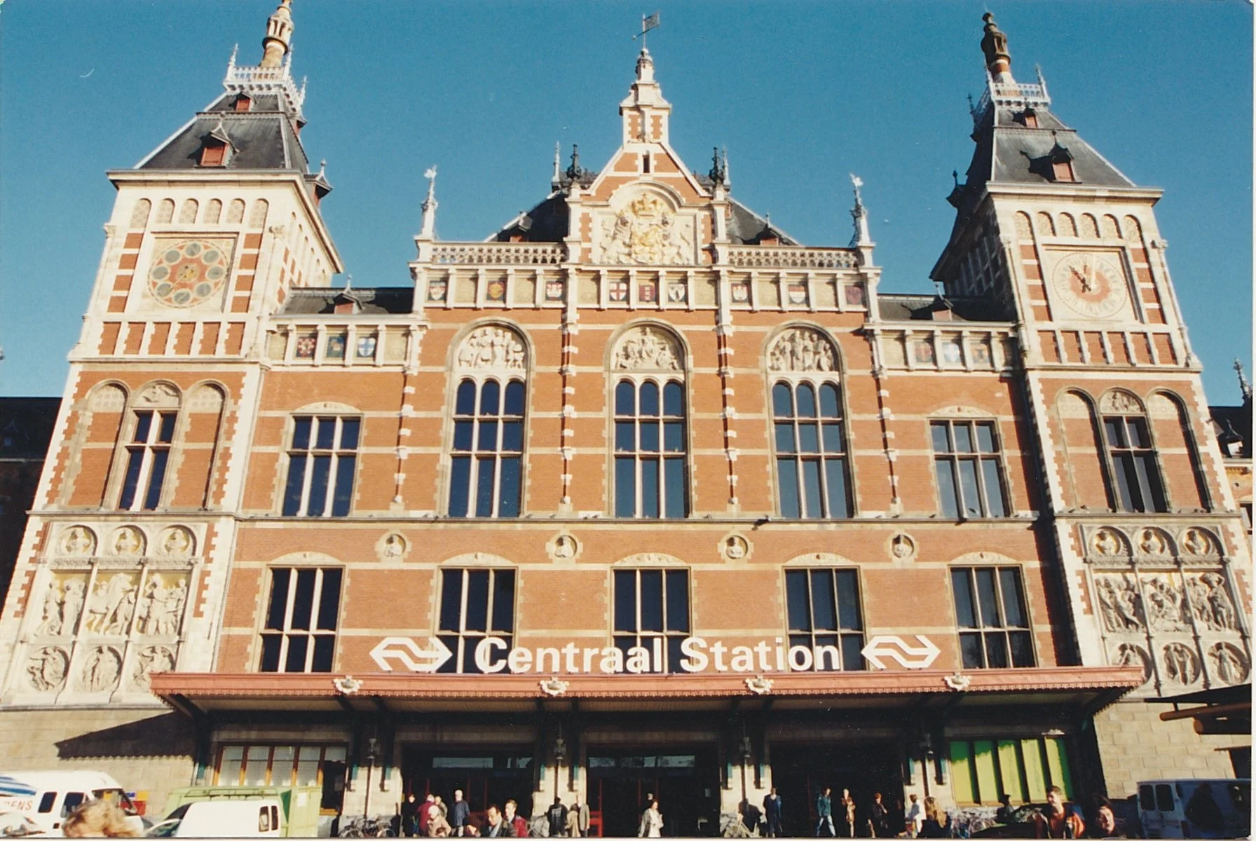 Ornate railway station façade featuring towers, clocks, and decorative stonework.