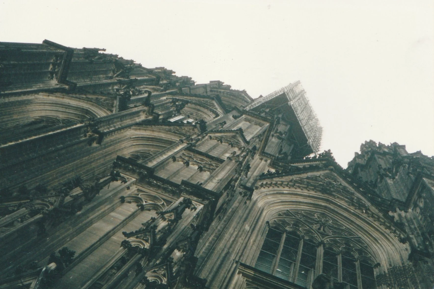 Dramatic upward perspective emphasizing the immense scale of a Gothic cathedral façade.