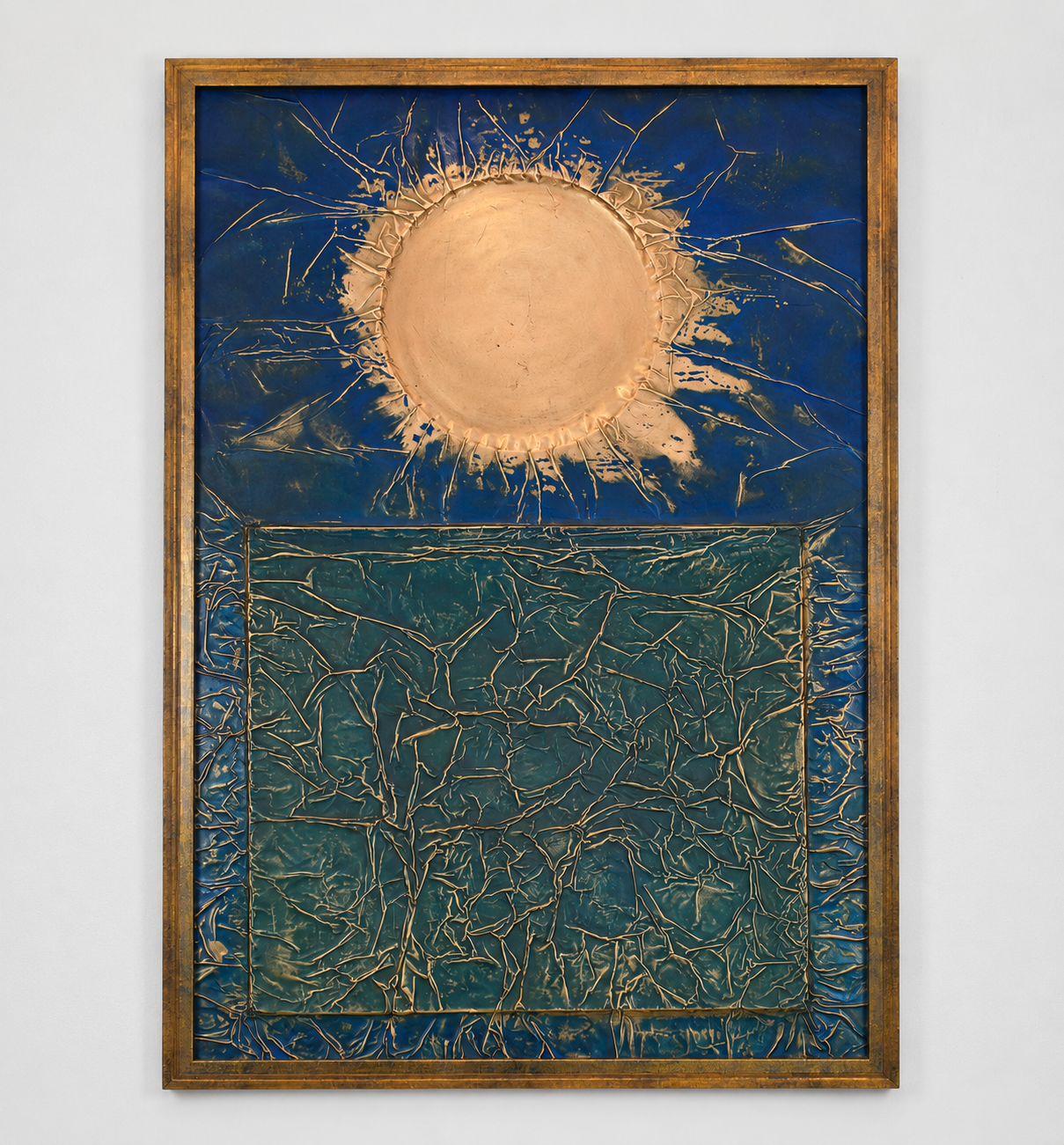A radiant golden orb dominates a deep blue expanse, its irregular rays spreading outward like a burst of solar energy. Displayed framed on a white wall.