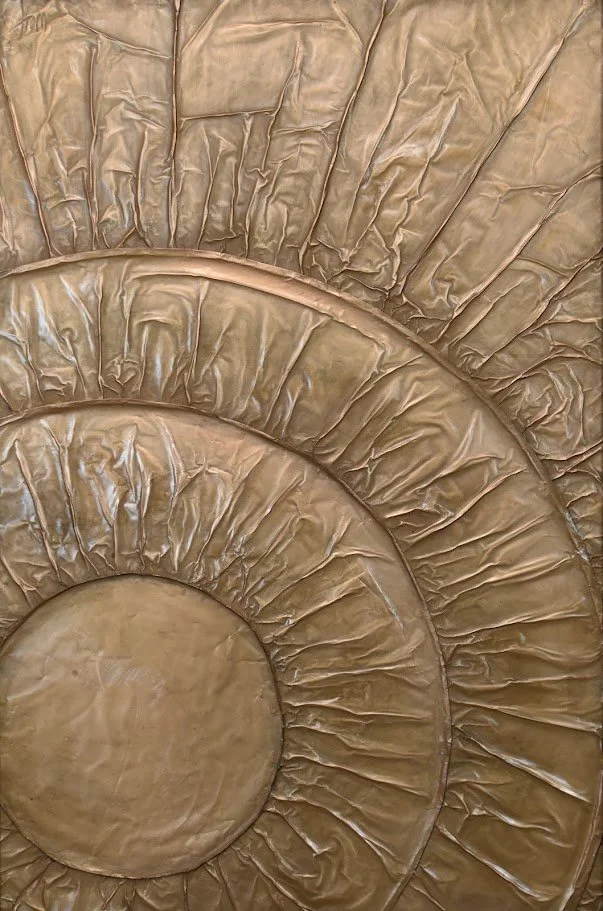 Concentric golden forms radiate outward like waves of energy. Shown close up without a frame.