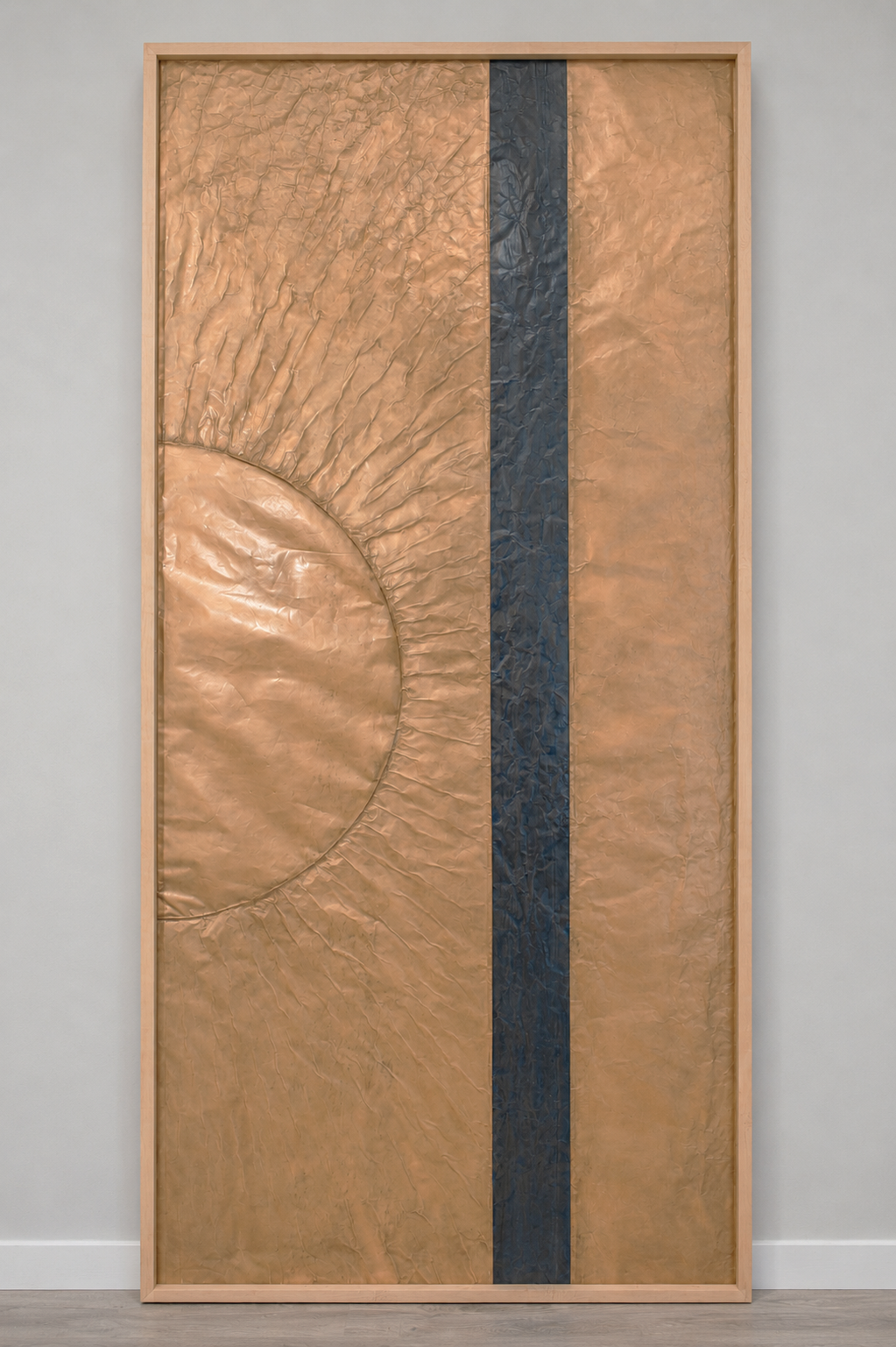 A golden orb intersects a dark vertical band. Displayed framed on a white wall.