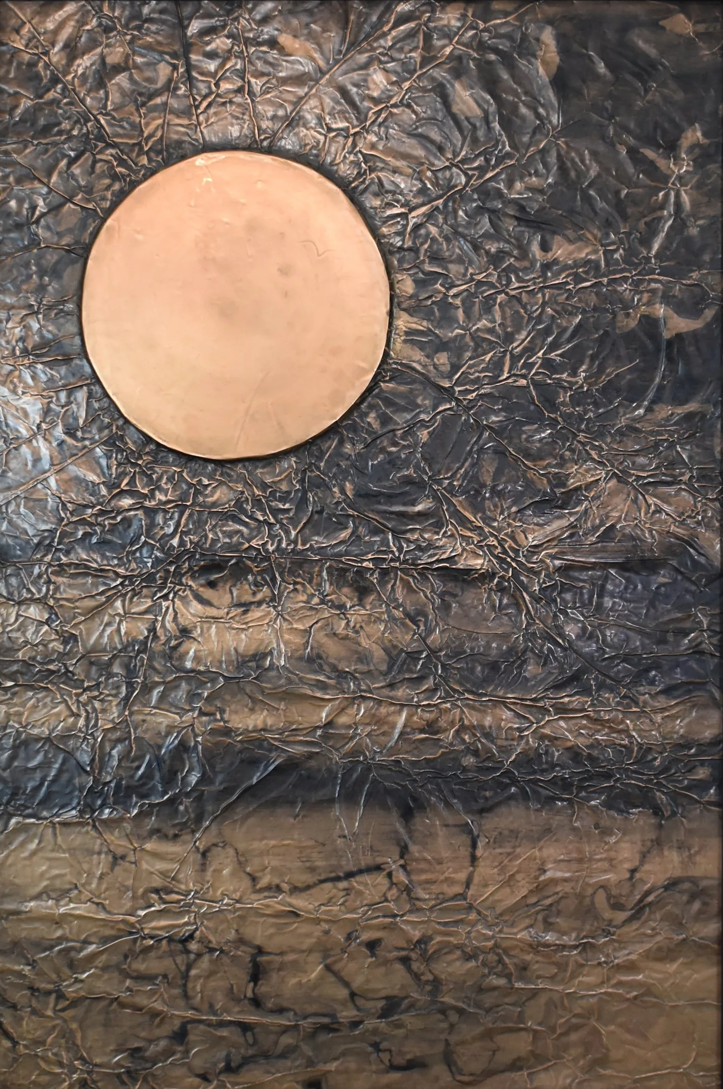 A golden orb floats within a dark, fractured metallic field. Shown close up without a frame.