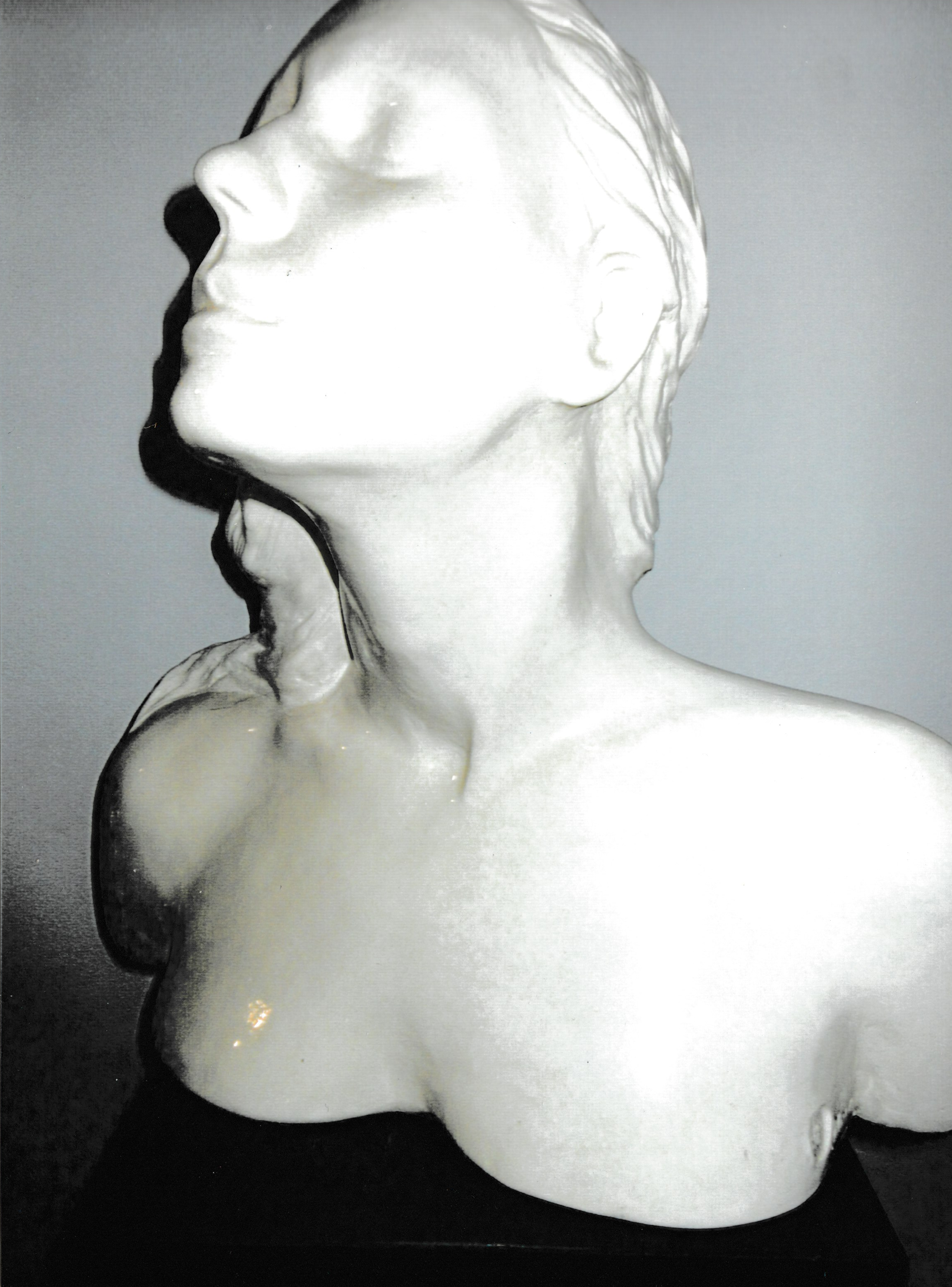 Ceramic life mask bust with head dramatically tilted back, exposing the throat and lifting the face toward the sky.