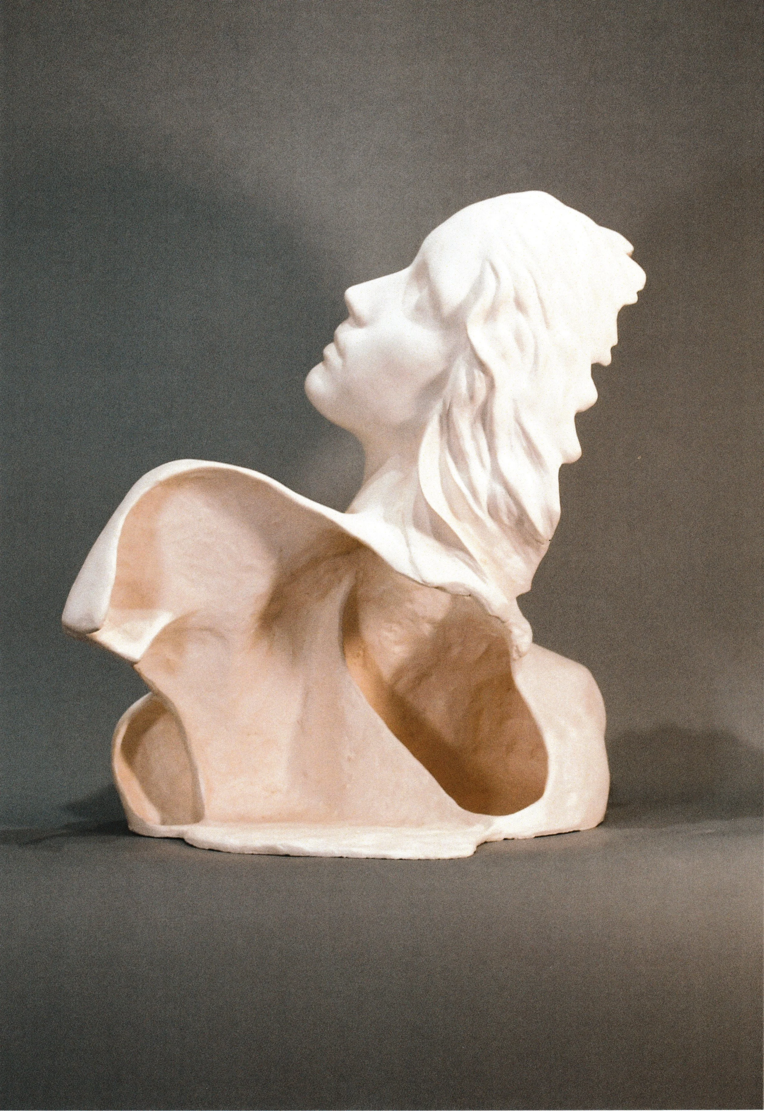 Side view of the same upward-looking ceramic life cast bust, emphasizing flowing hair and an open, expansive posture.