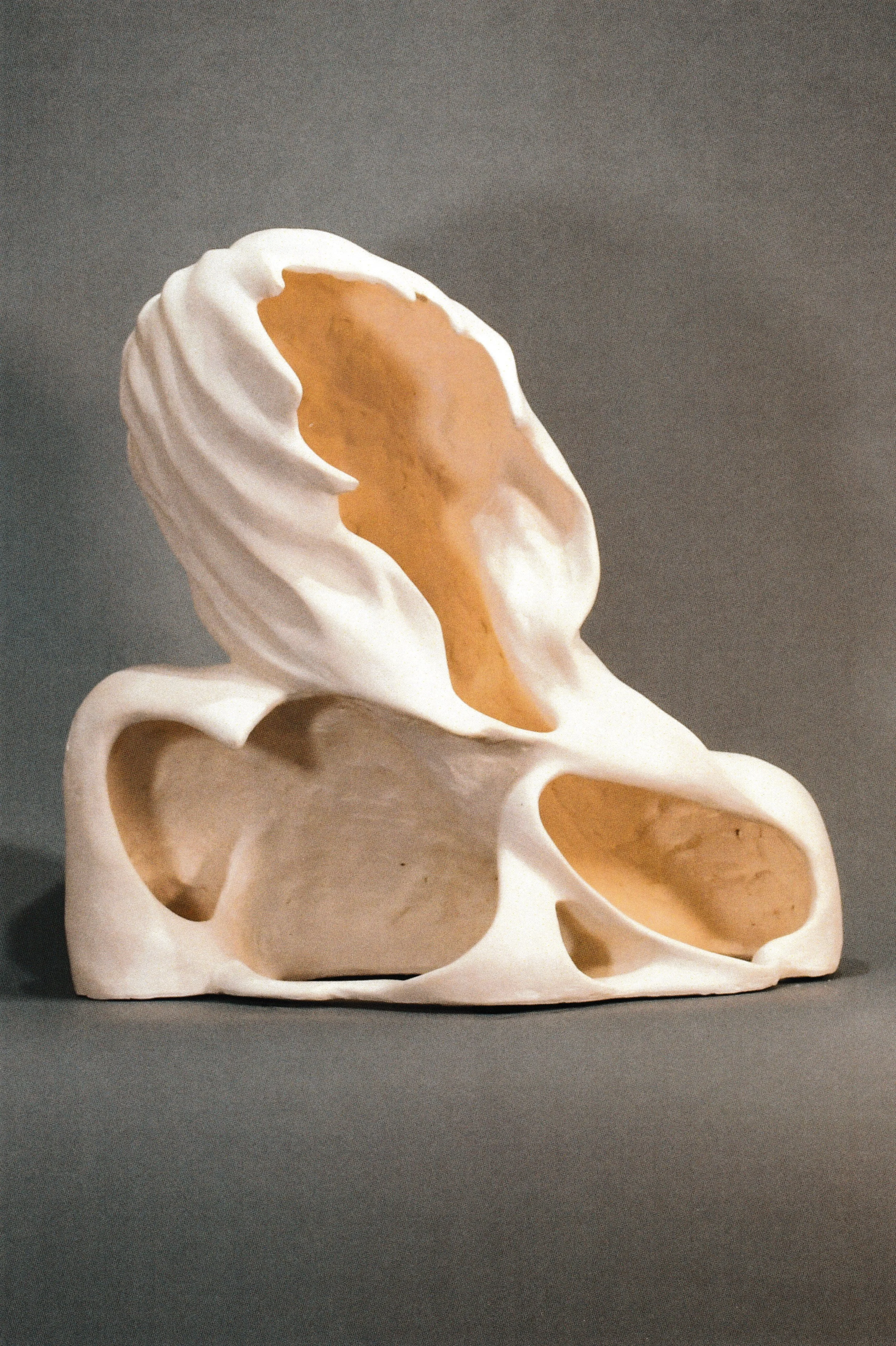 Back view of the same upward-looking ceramic life cast bust, emphasizing flowing hair and an open hollow shell completing the sculpture.