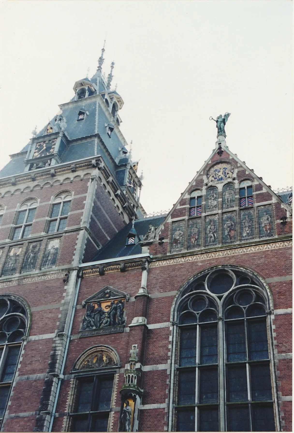 Historic brick and stone building with richly decorated gables and arched windows.