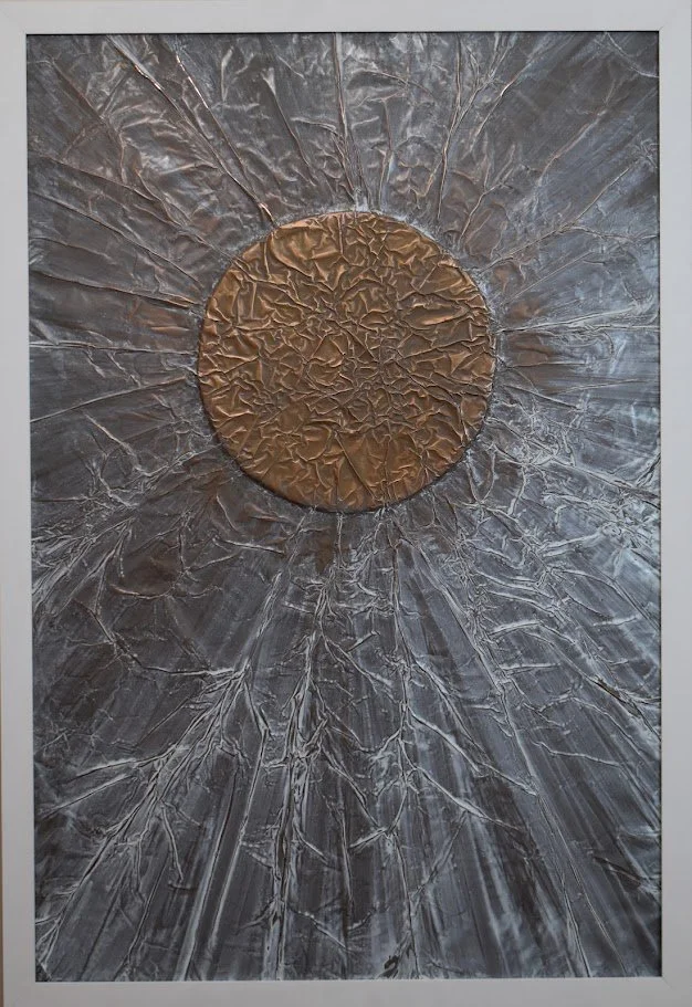 A copper orb radiates across a silvery metallic field. Shown close up in a white frame.