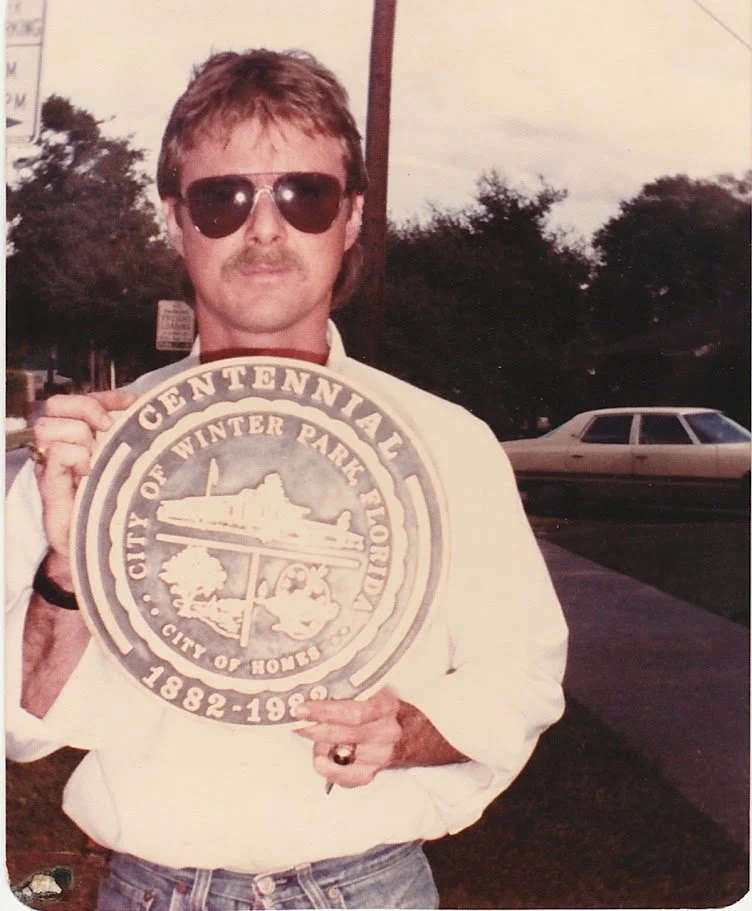 Whitney Wolf II holding the Winter Park, Florida Centennial bronze seal that he made. Circa 1982
