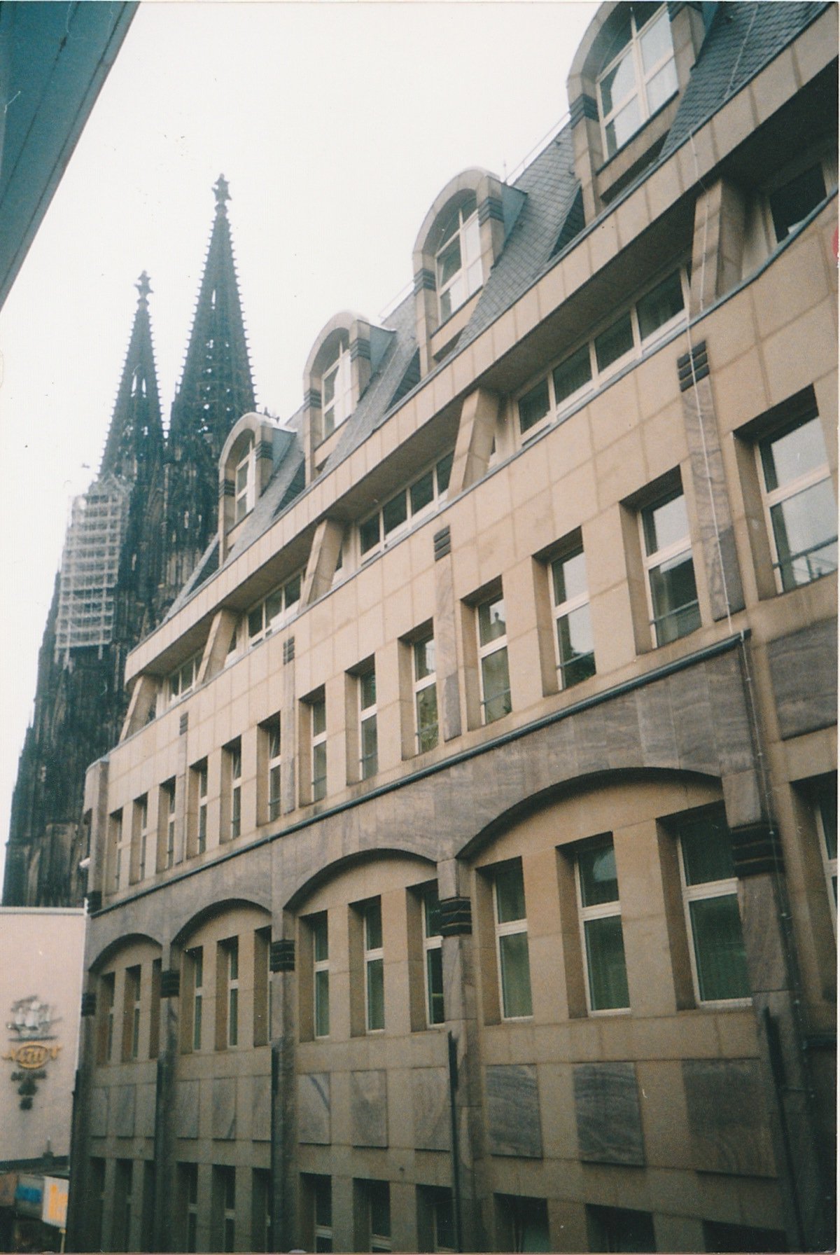 Historic building façade with Gothic church spires visible beyond the rooftops.