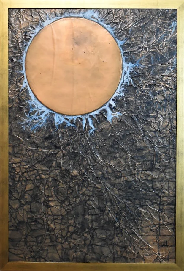 A copper orb glows against a dark, fractured field. Shown close up in a golden frame.