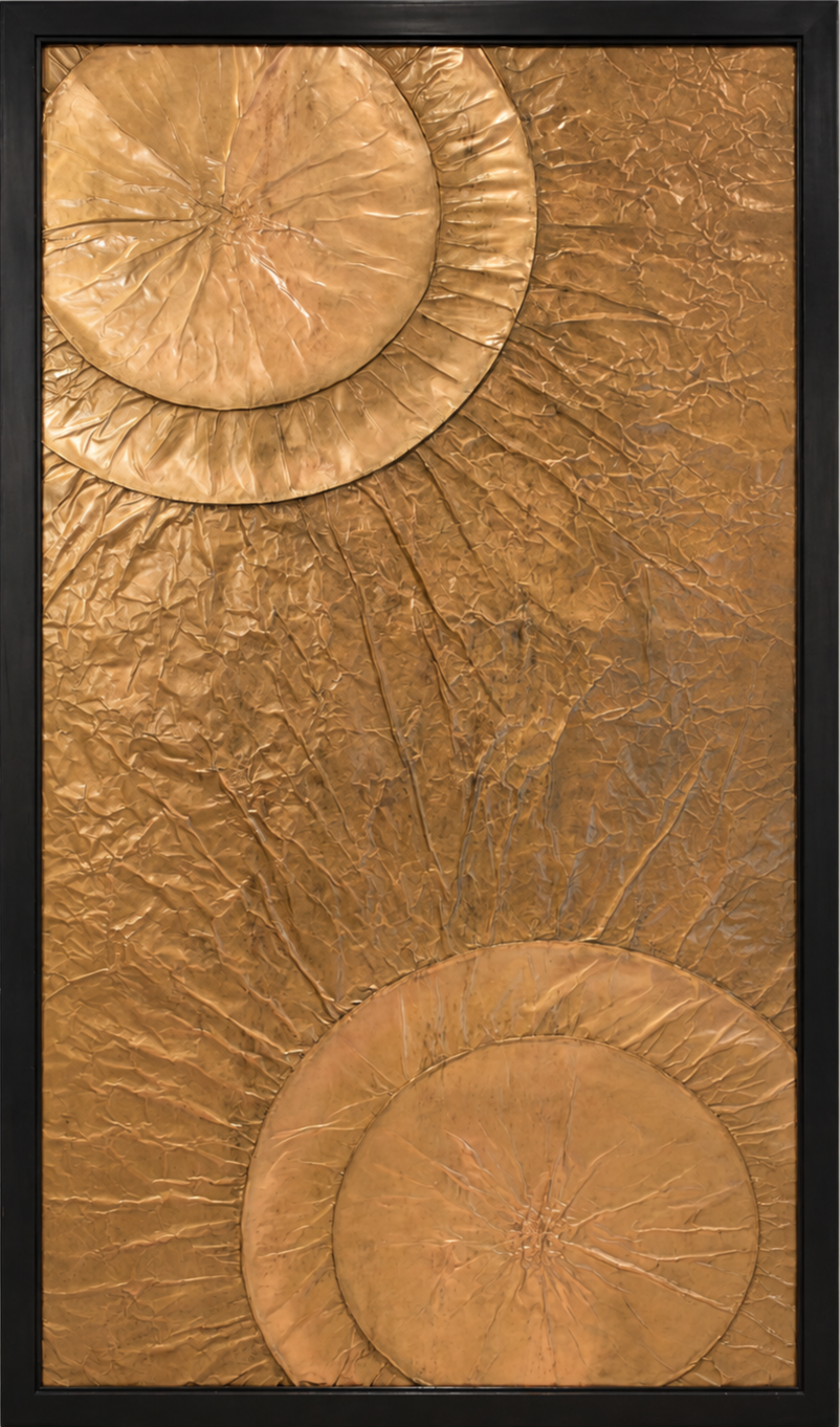 Large overlapping circular forms emerge from opposite corners of a warm metallic field. Shown close up in a black frame.