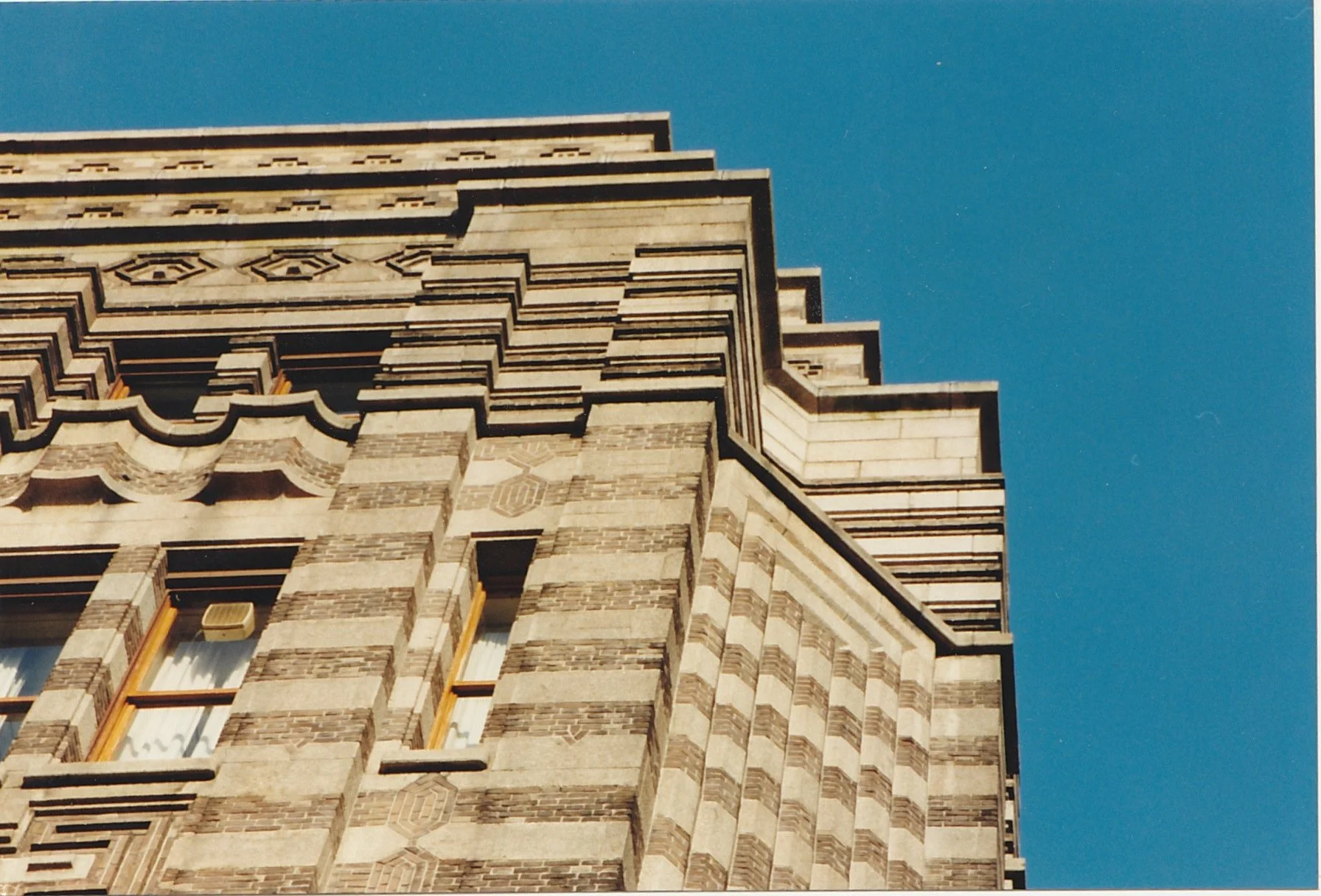 Low-angle view emphasizing the geometric patterns of a monumental stone building.