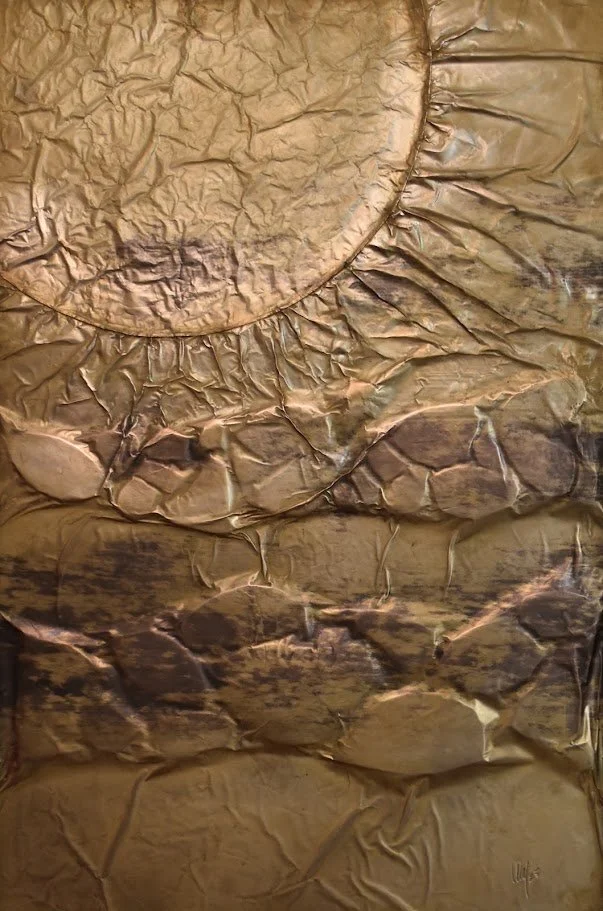 A golden orb rises above layered, fractured metallic forms. Close up without a frame.