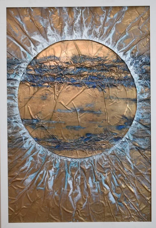A golden orb radiates through currents of blue and silver. Shown close up in a white frame.
