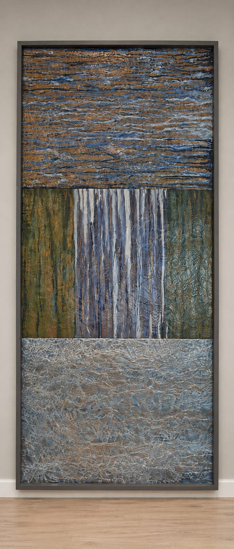 Layered bands of blue, green, and silver create an abstract metallic landscape. Displayed framed on a white wall.