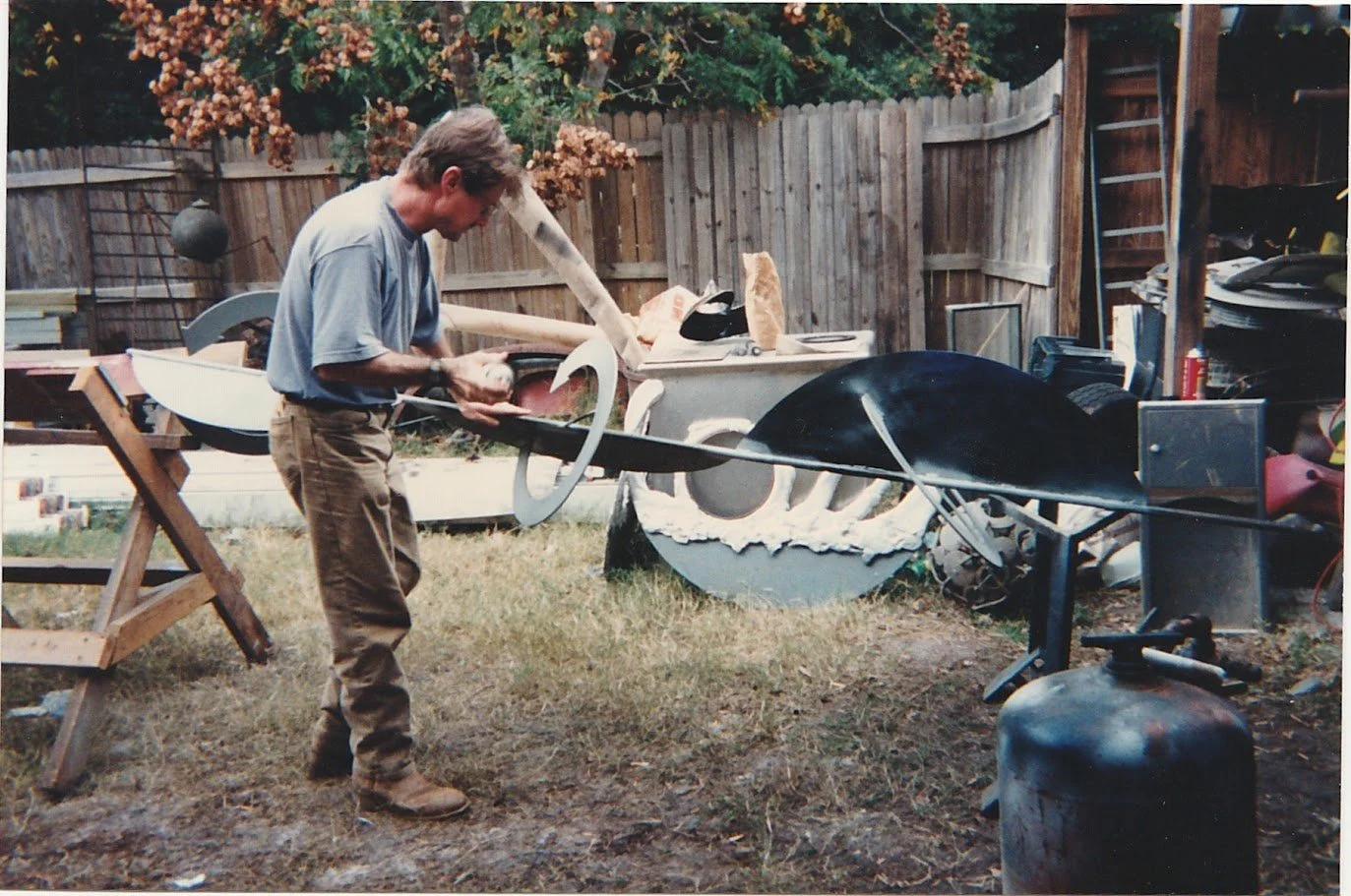 Whitney Wolf II working on a sculpture in the backyard of his studio. EST 1990s